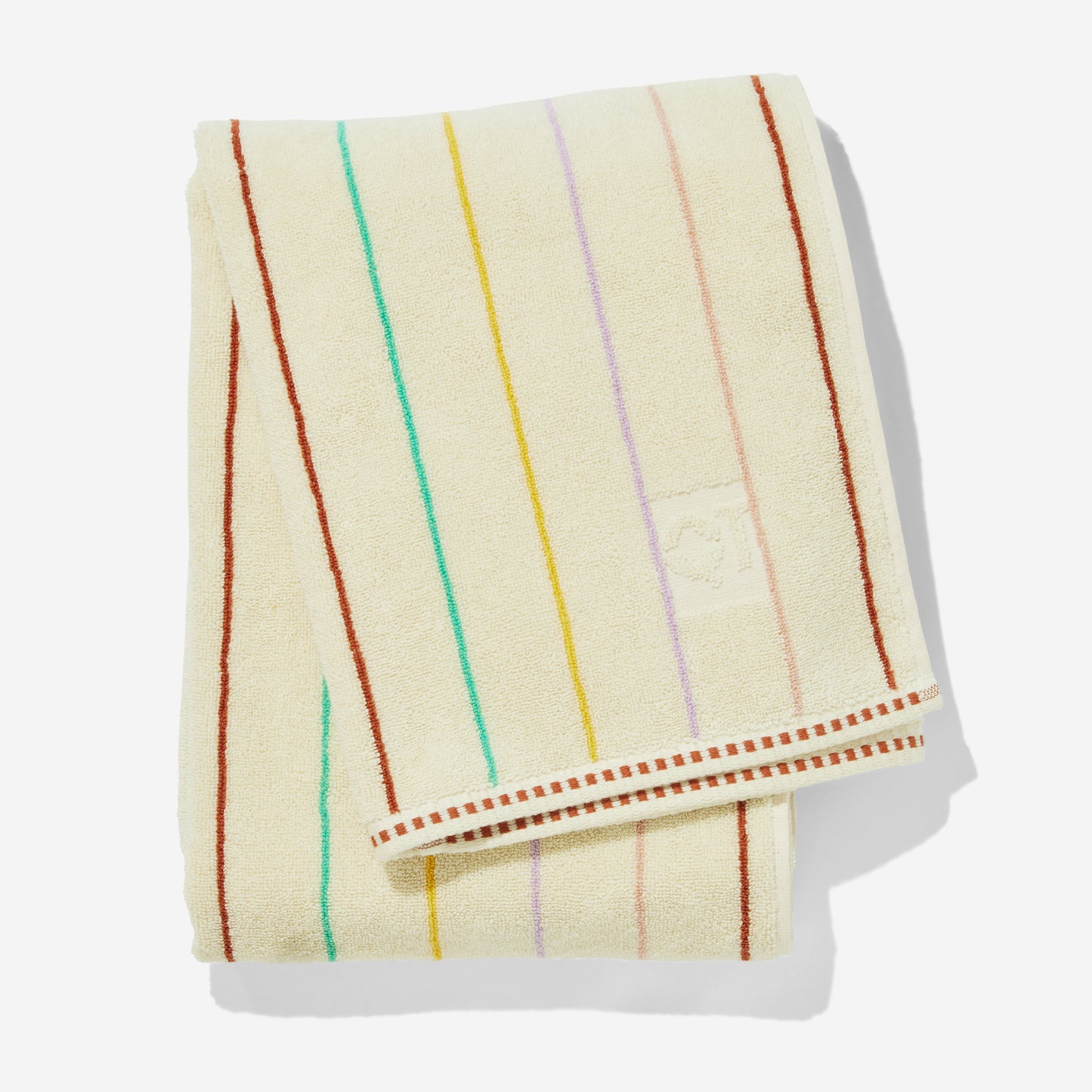Folded prism bath towel with multi-color pin stripes in clay, green, yellow, lavender, and rose.