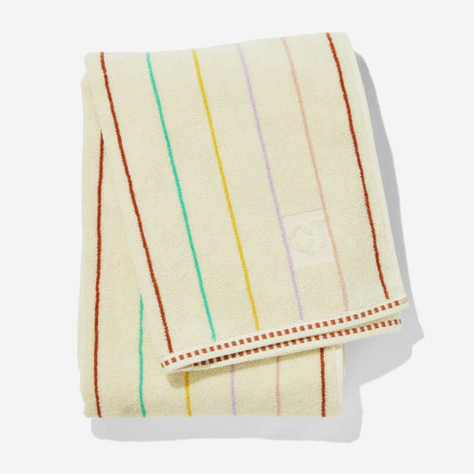 Folded prism bath towel with multi-color pin stripes in clay, green, yellow, lavender, and rose.