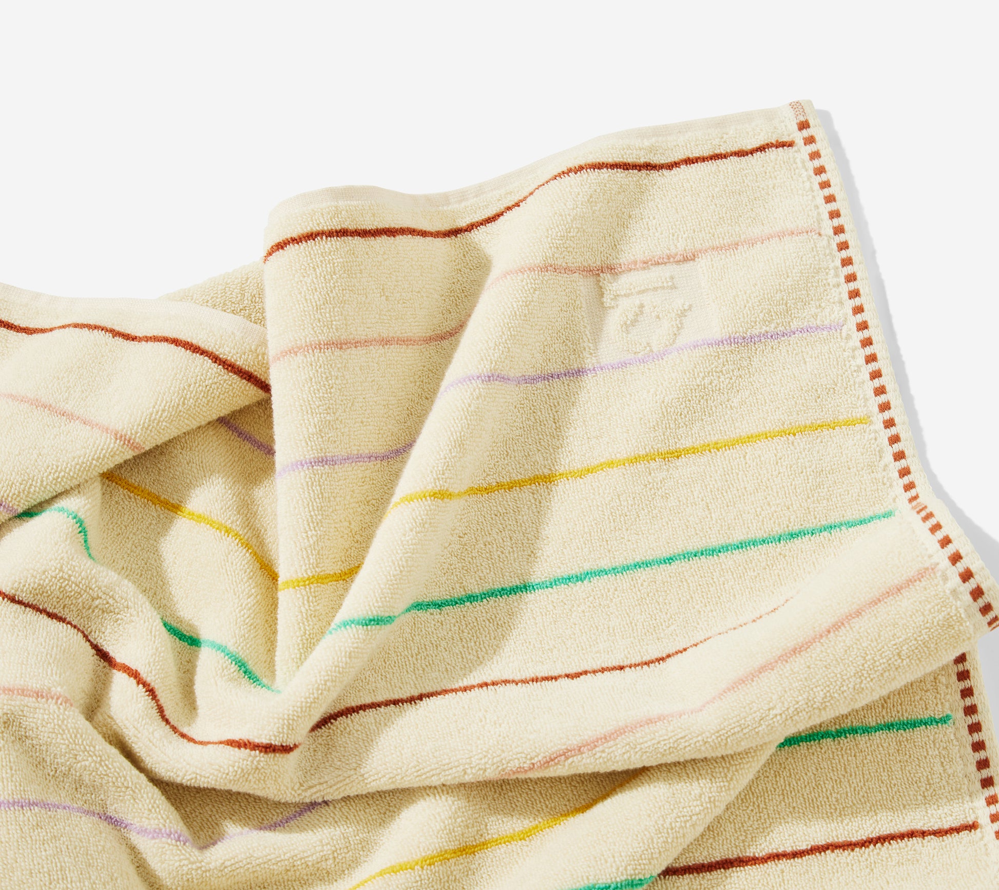 Corner detail of the prism hand towel and embossed QT logo.