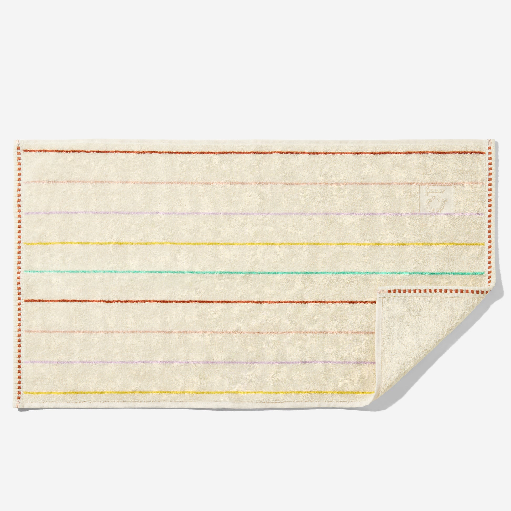 Prism hand towel with multi-color stripes laid flat with corner flipped up showing blank back side.