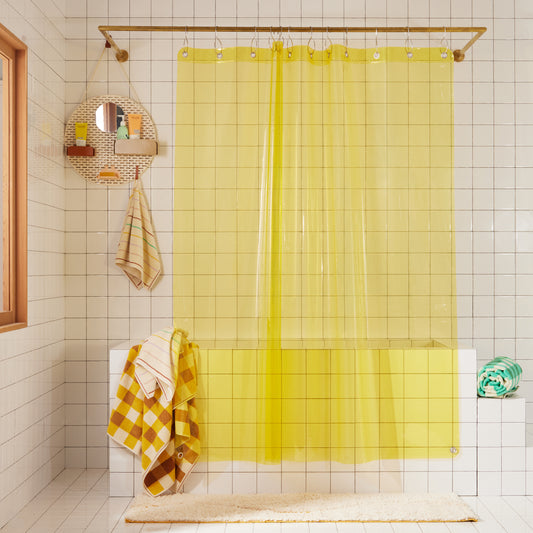 Full length Sunny Sun Shower curtain styled with our Spot shower organizer in Sand, Prism hand towel and bath towel, Tam Canyon bath sheet and Tam Pine bath sheet.