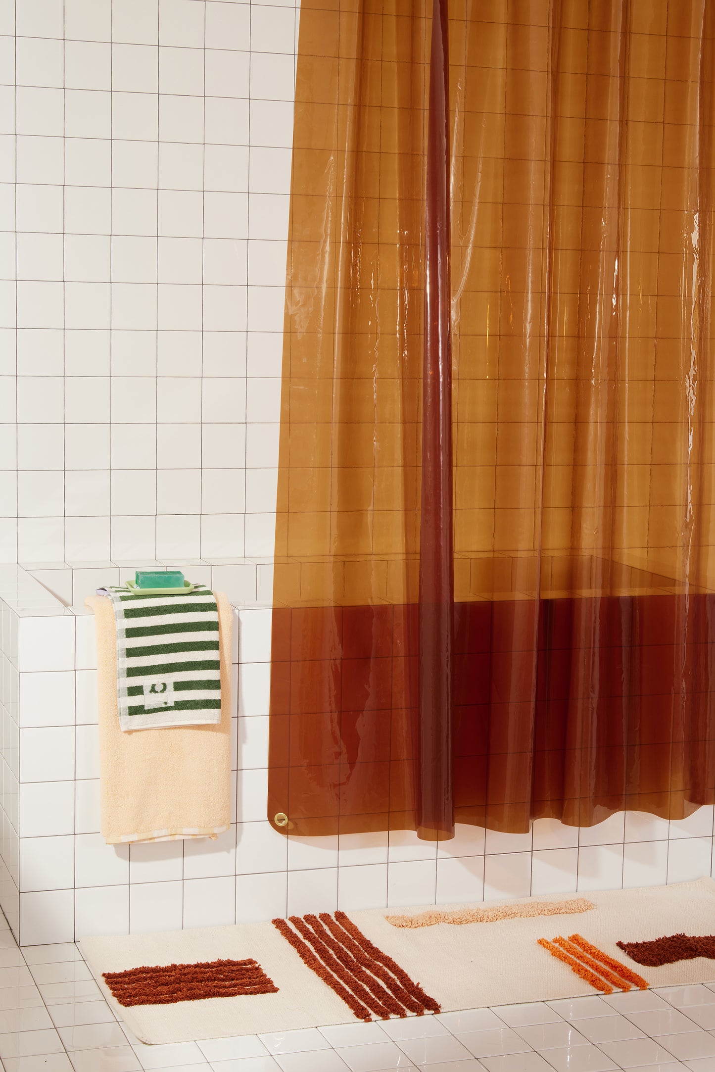 Sun Shower Honey detail view of front corner of curtain hanging in a bathroom.