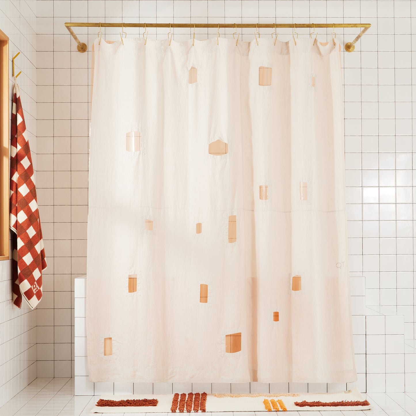 Full view of ronchamp linen shower curtain in sand in white tiled bathroom.