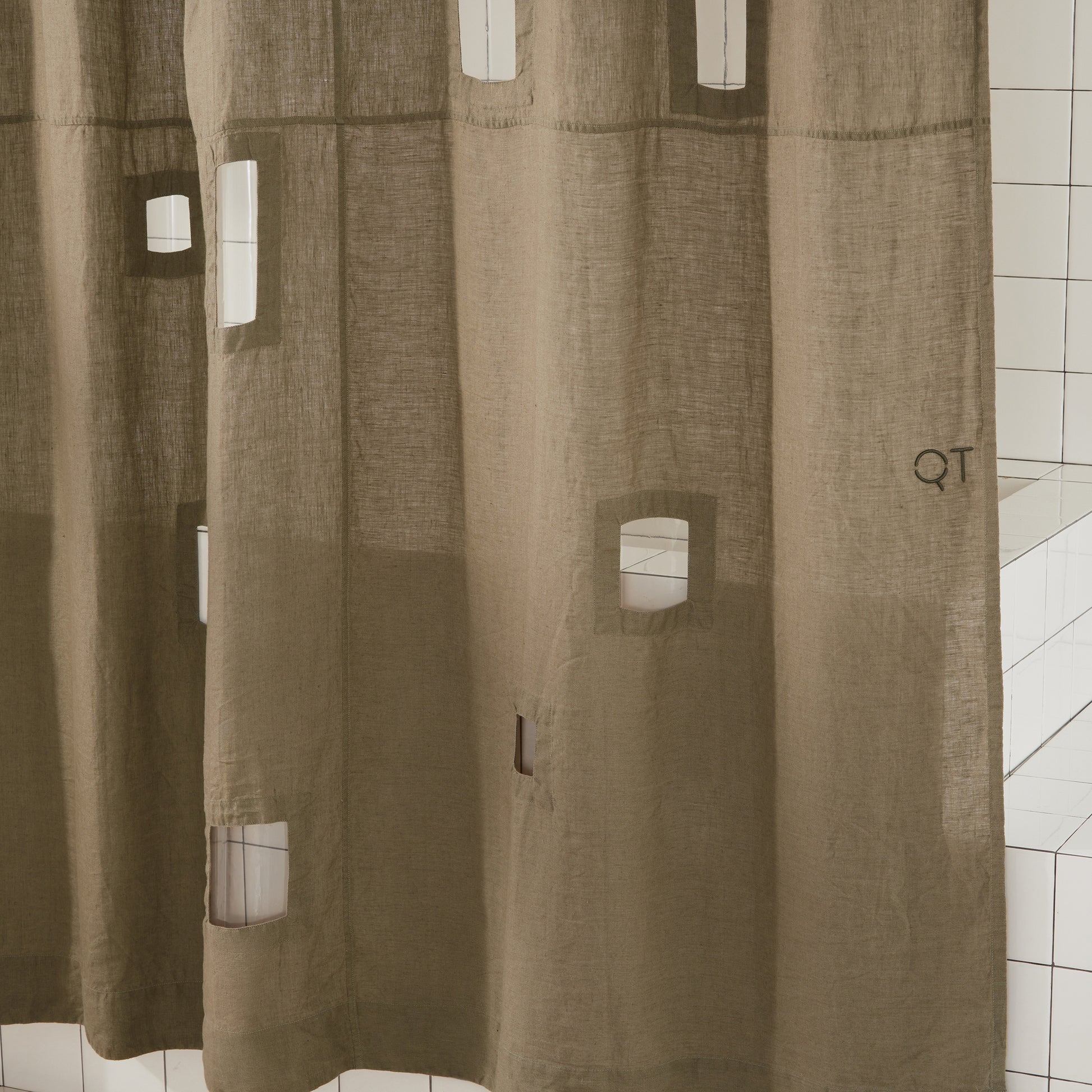 Side detail shot of ronchamp linen curtain in olive.