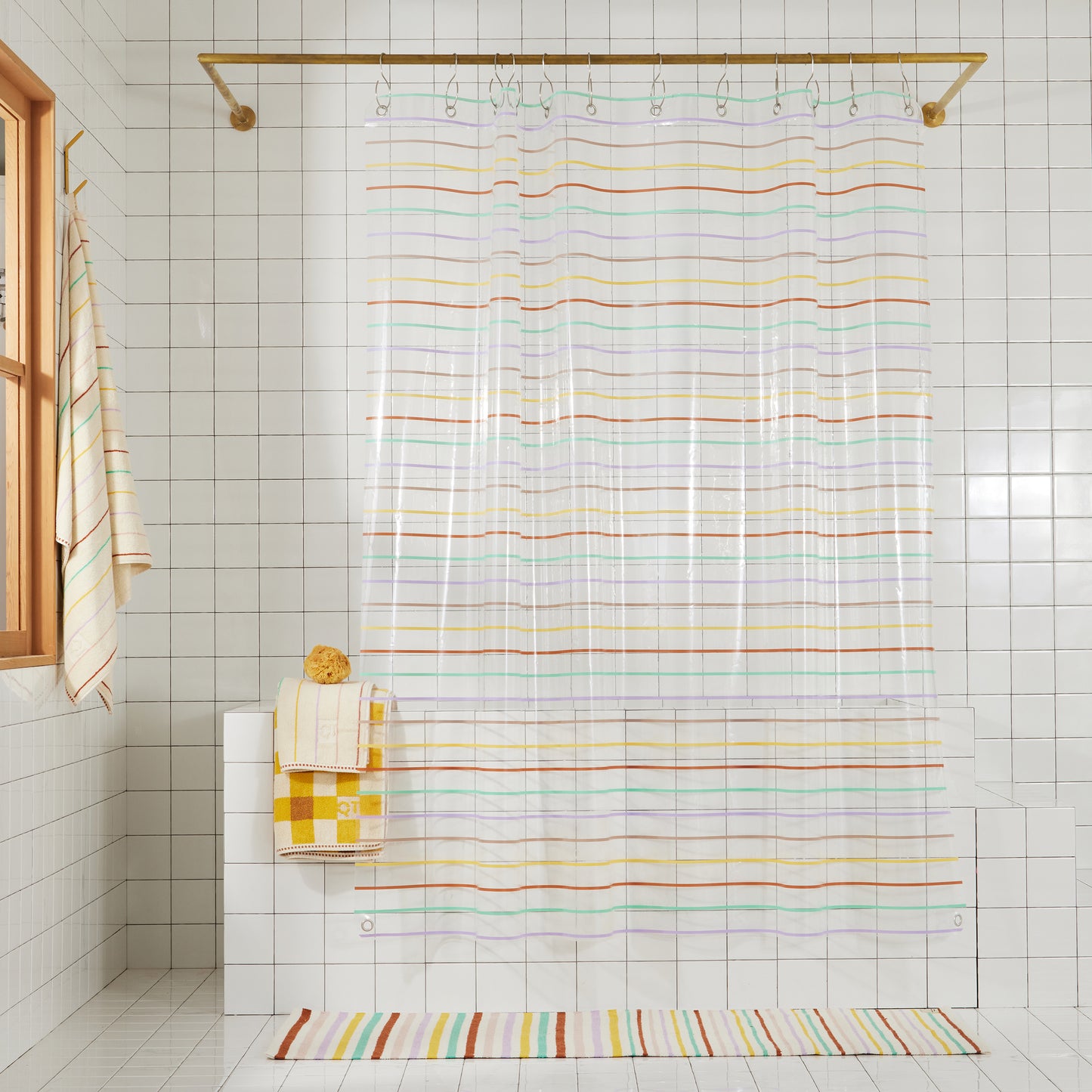 Full length shower curtain with multi-color horizontal pin stripes. Stripes are green, rose, lavender, yellow, and clay.