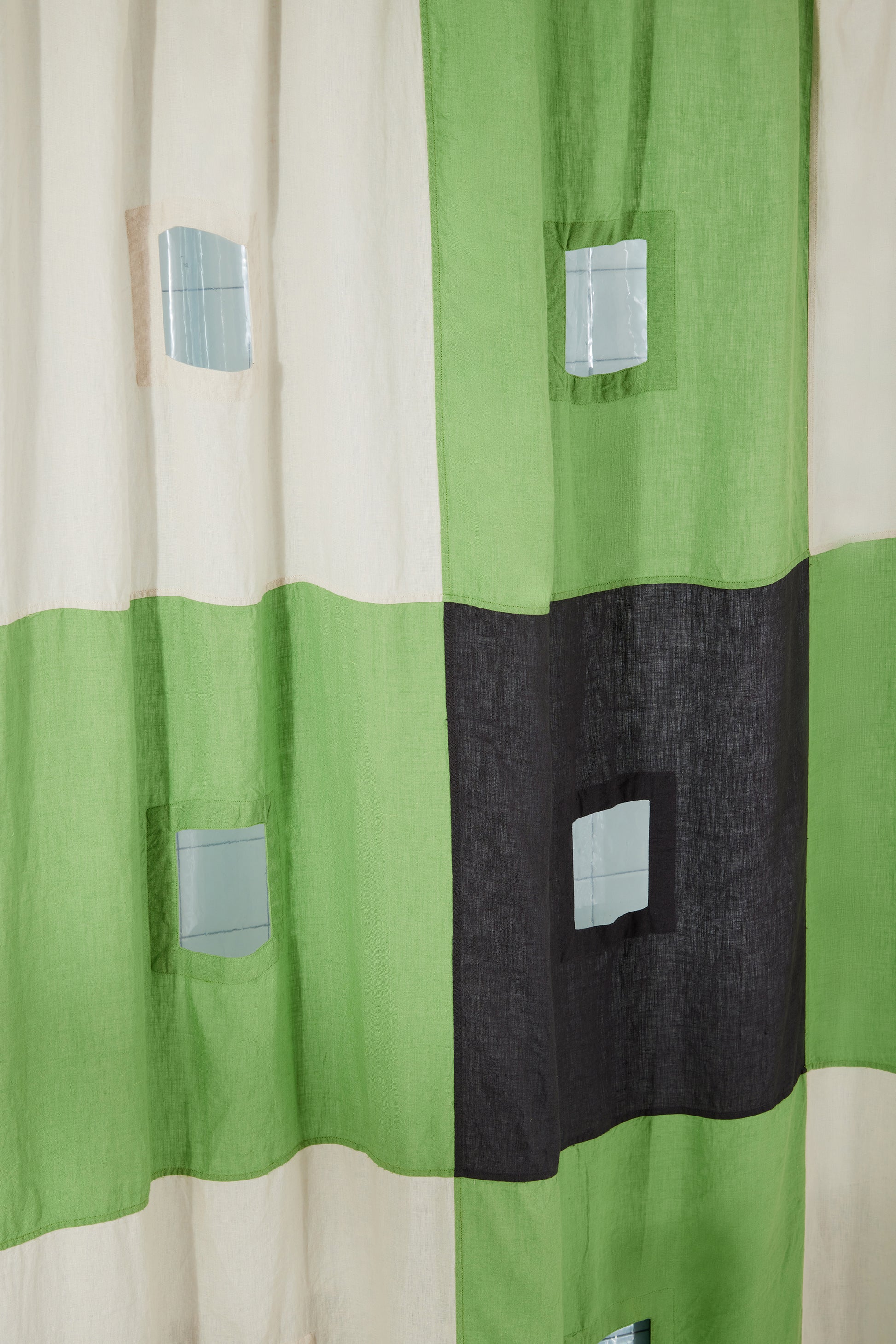 photo of cut out details in green and charcoal linen curtain.