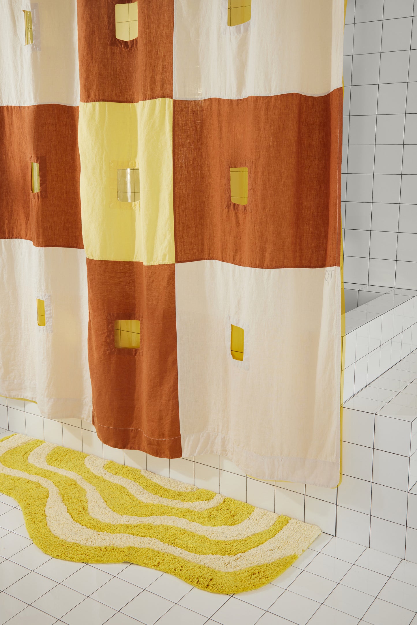 Right side and bottom hem details are featured in this clay and yellow checker linen shower curtain.