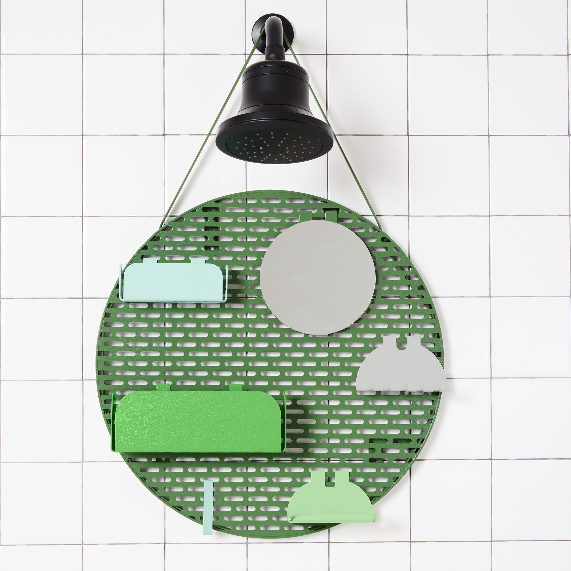 The spot modular shower organizer with shelving pieces arranged hanging in a white tiled shower.