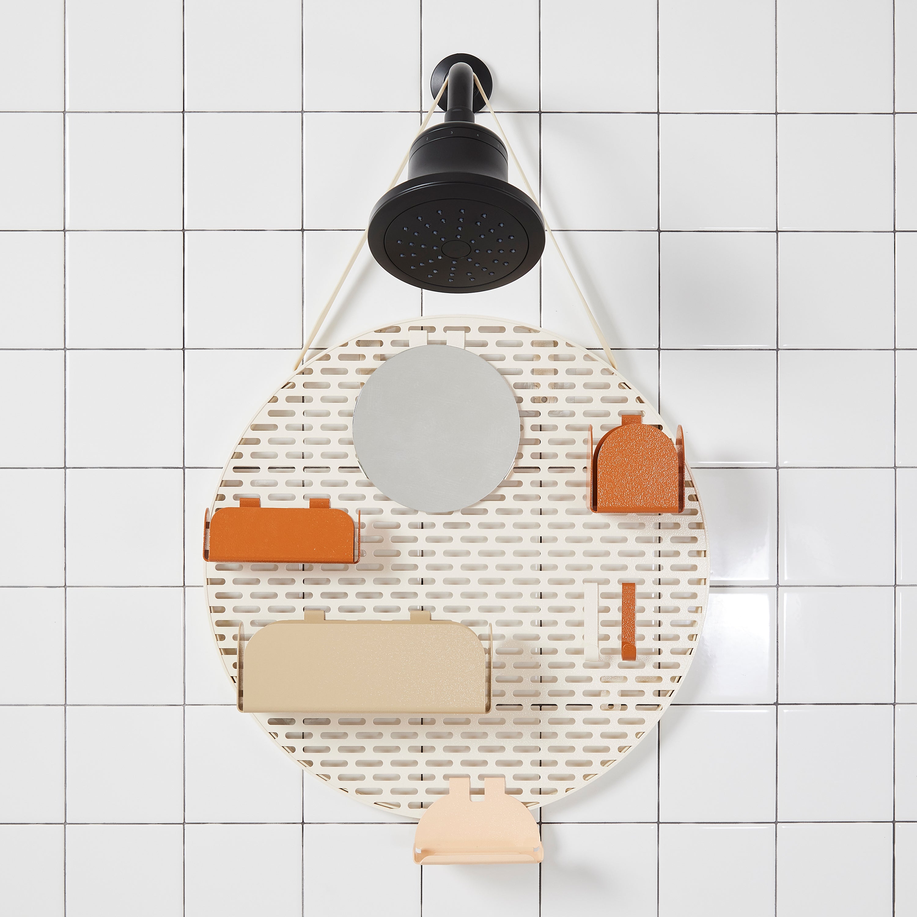 The spot modular shower organizer with shelving pieces arranged hanging in a white tiled shower.