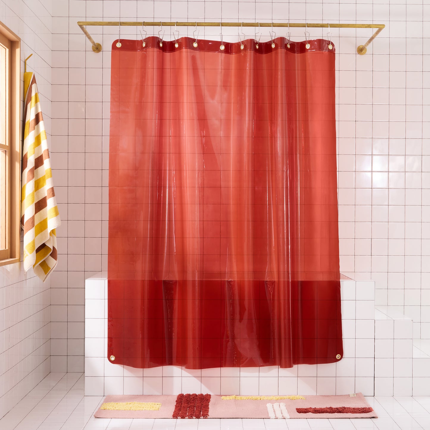 Sun Shower Brick front view of curtain hanging in a white tiled bathroom.