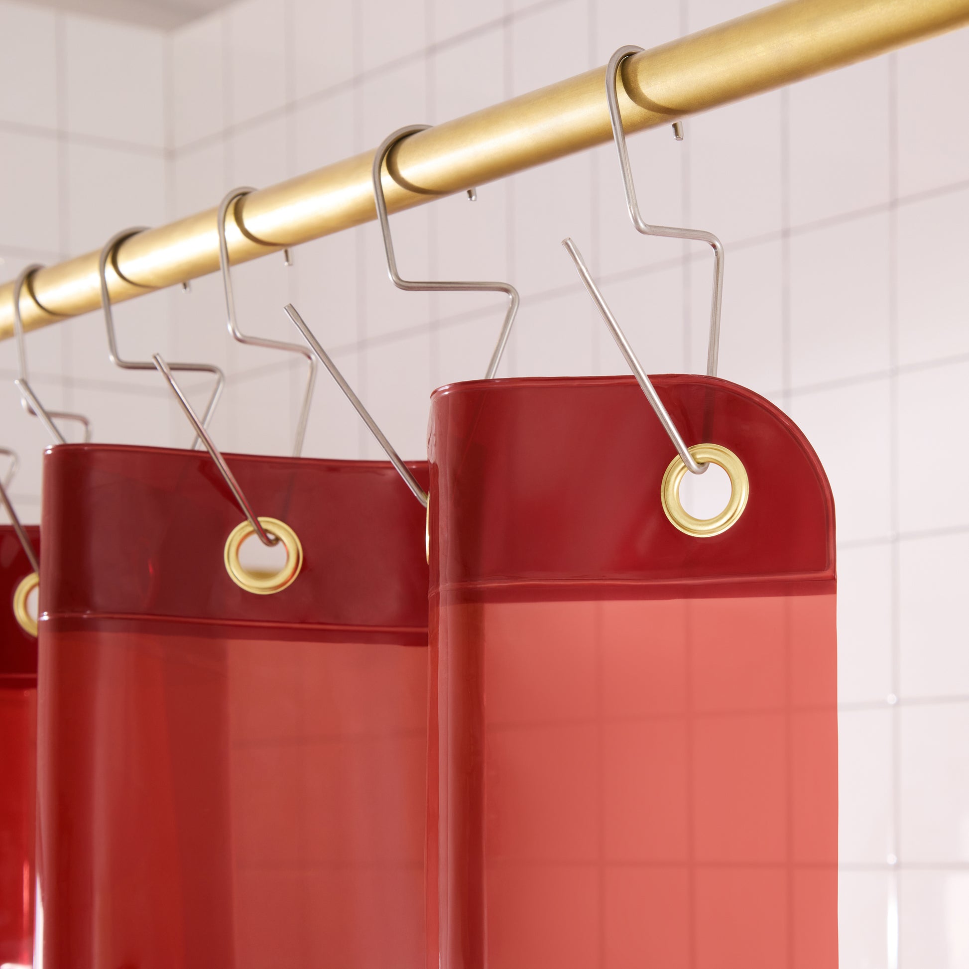 Top seam of Sun Shower Brick curtain hanging on brass rod with silver venice hooks.