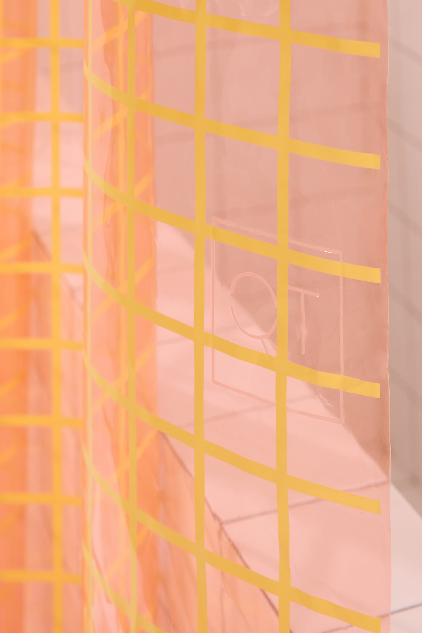 Close up detail of 2x2 yellow grid pattern of sun shower curtain in peony.
