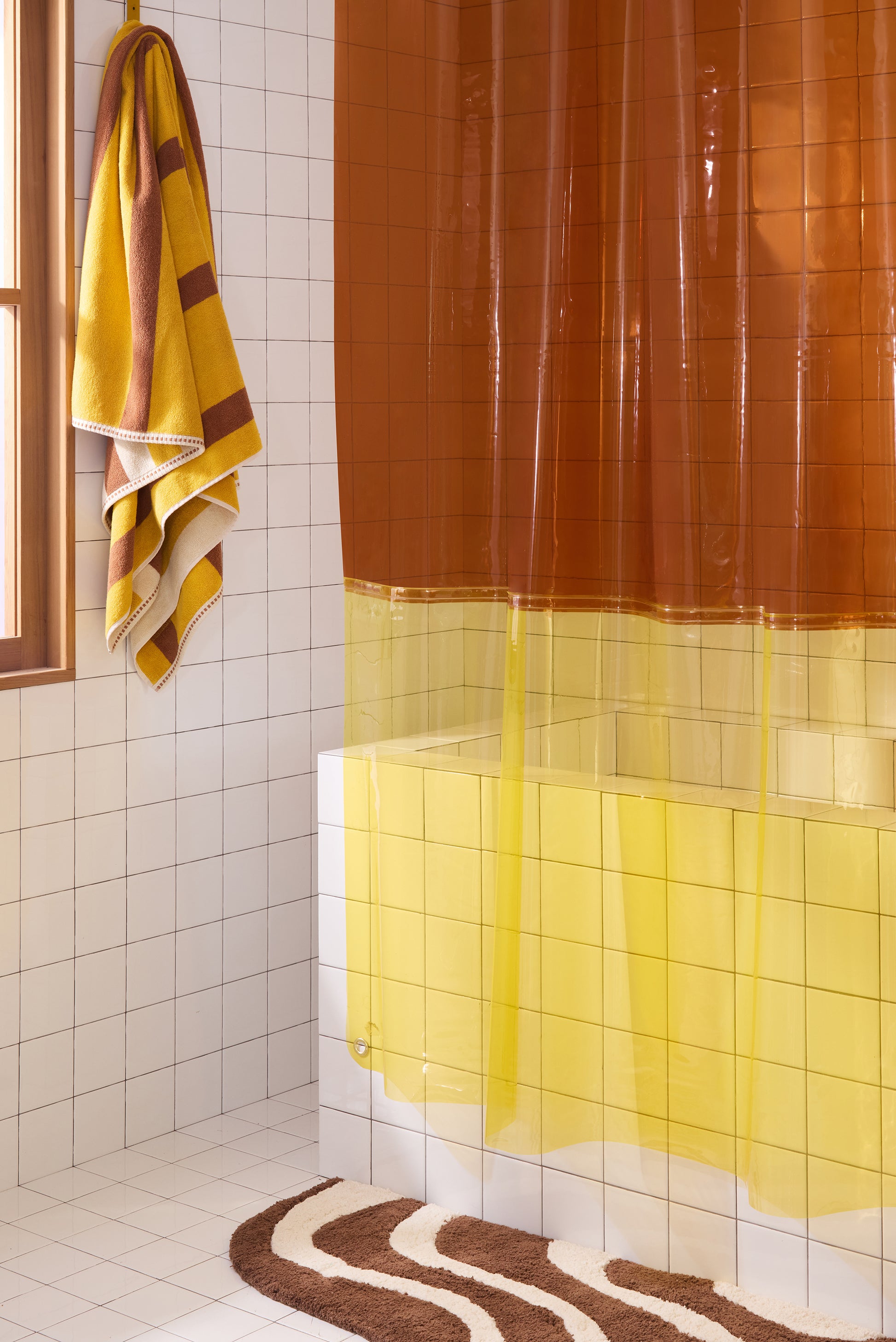 Color blocked orient shower curtain in cheetah hanging in bathroom with chocolate lost coast rug.