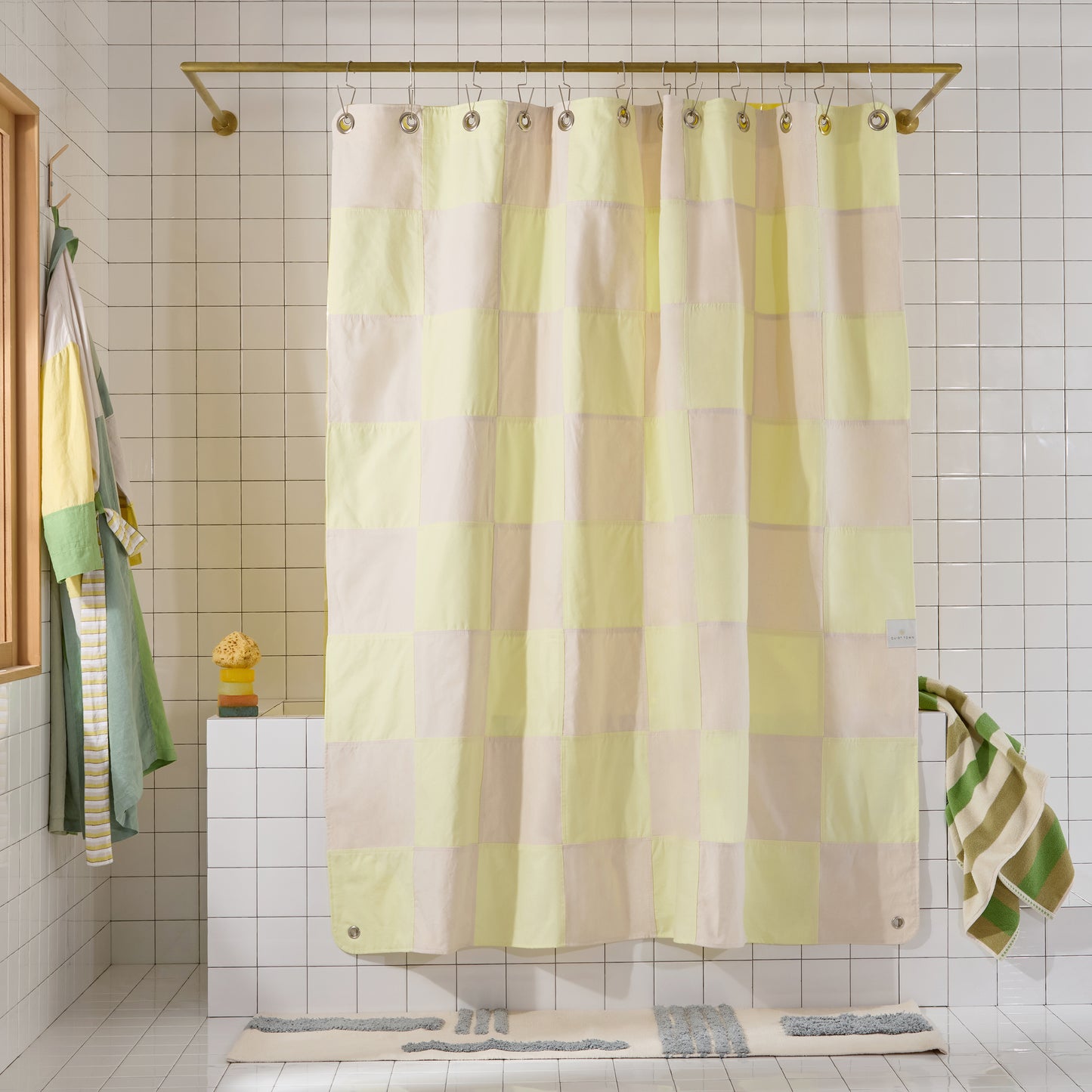 Checkered shower curtain in a bathroom with tiled walls and a bathtub.