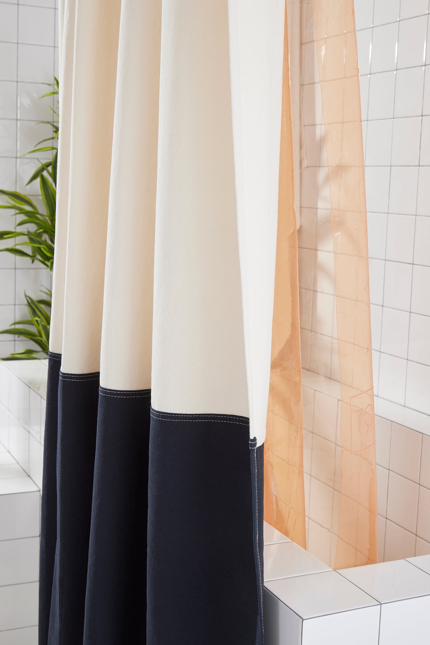 Shower curtain with black and white design in a bathroom setting