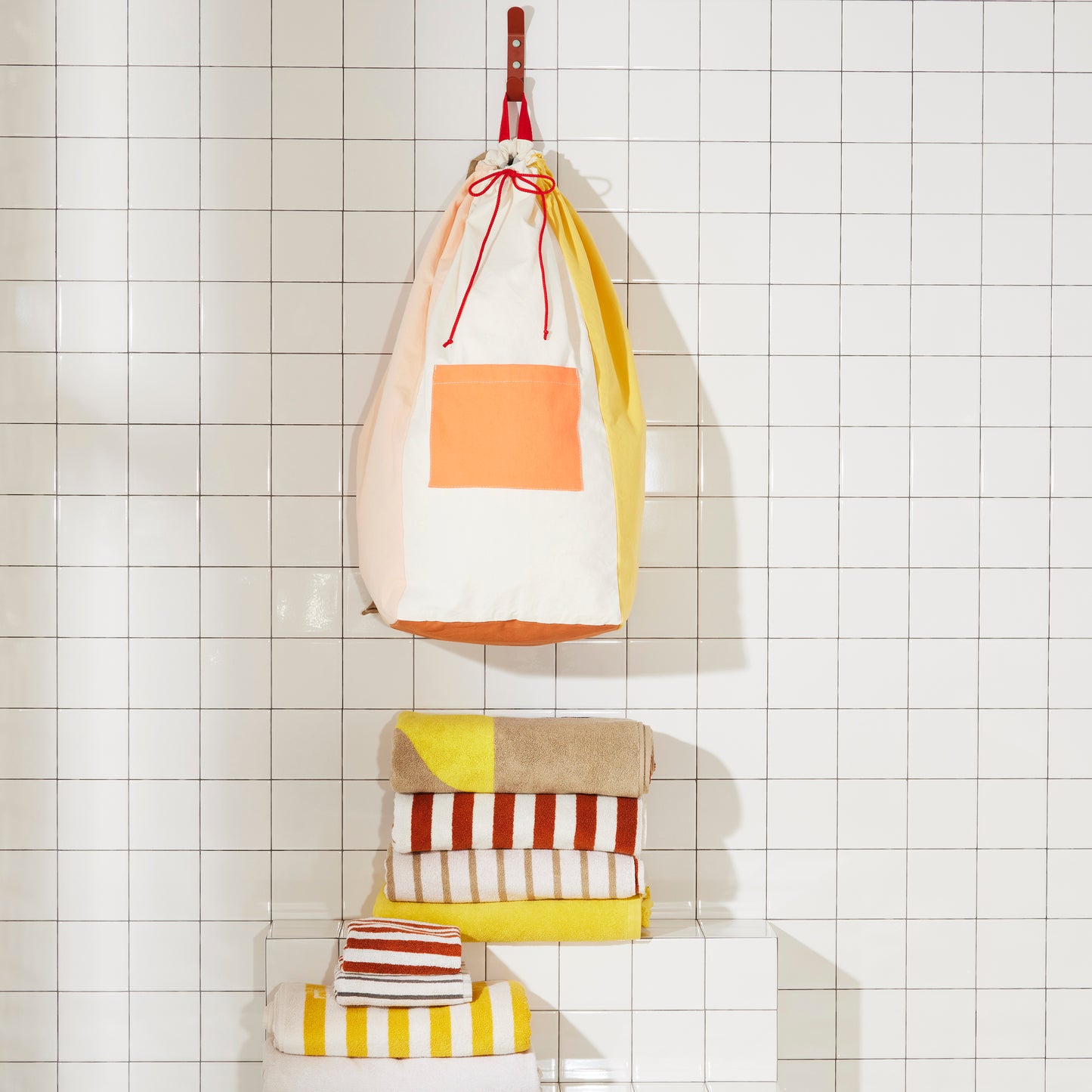 Re:Canvas Laundry Bag Clay Hanging on bathroom wall