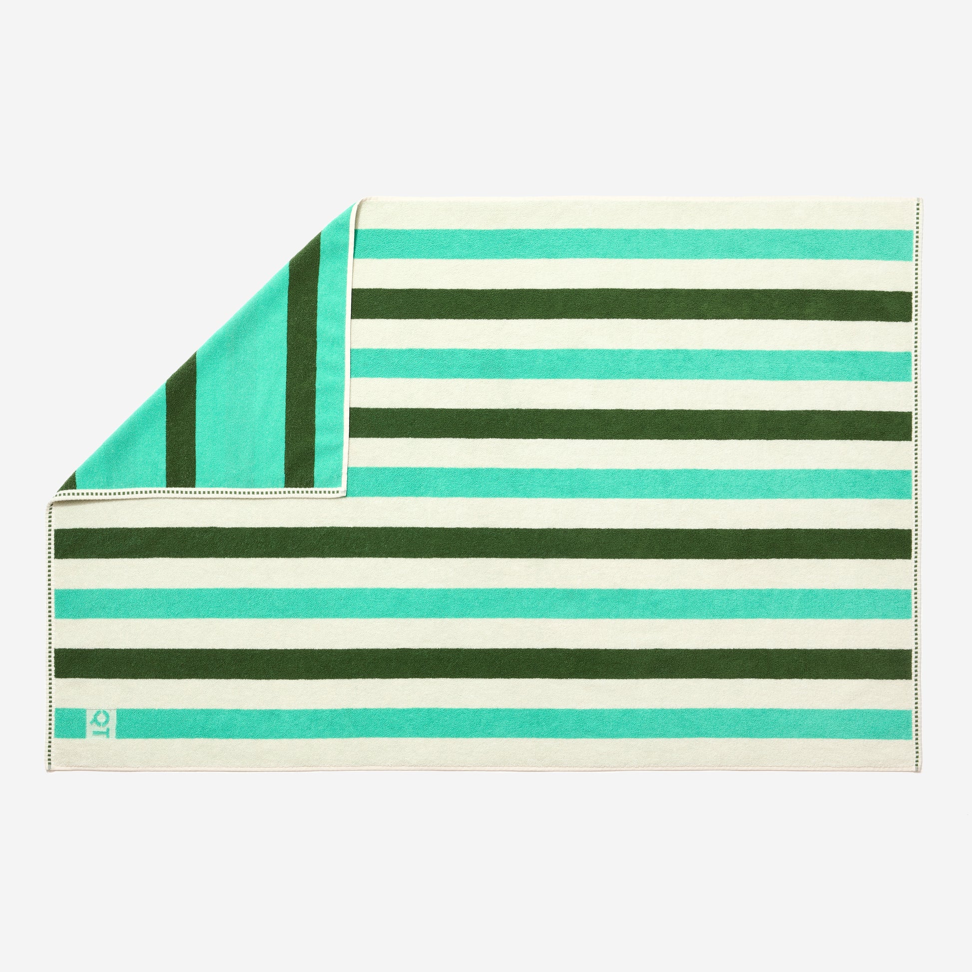 Full view of catalina bath sheet in pine laid flat with one corner folded up showing double sided stripes in pine, jade, and cream.