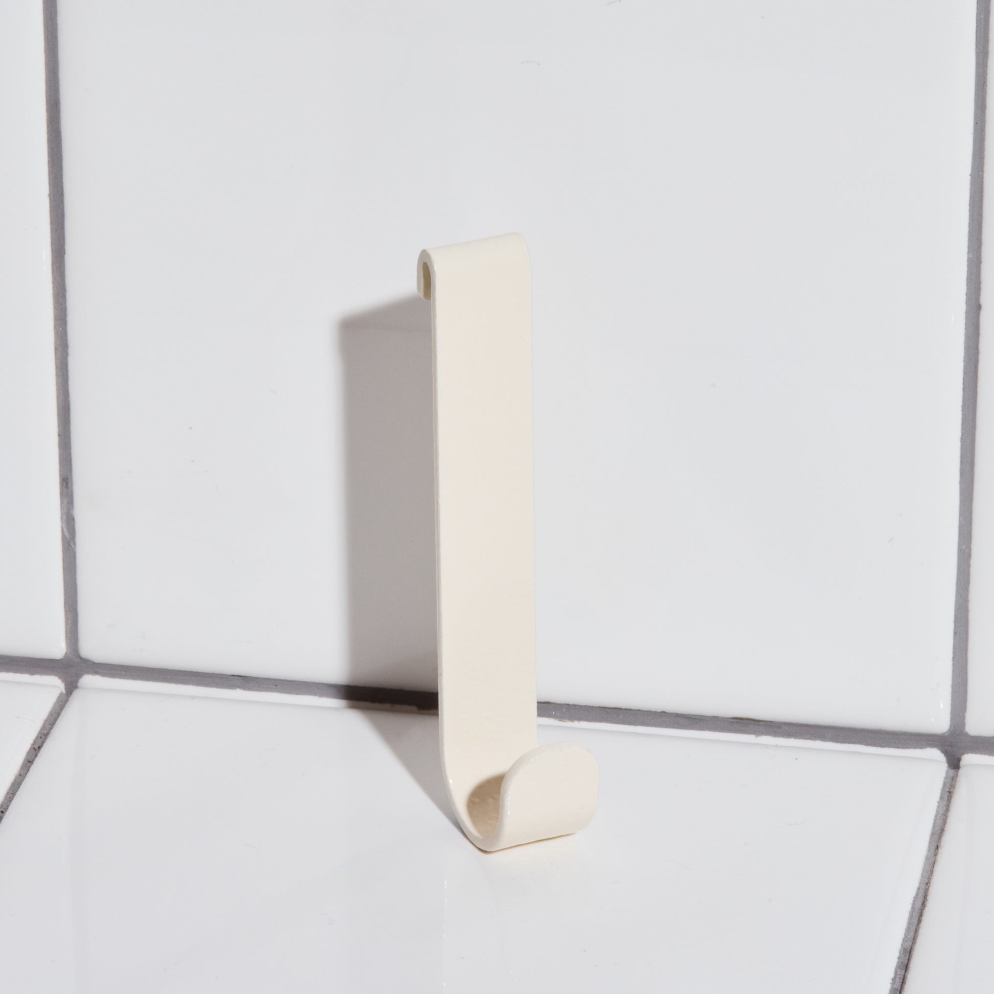 Aluminum hook in sand.