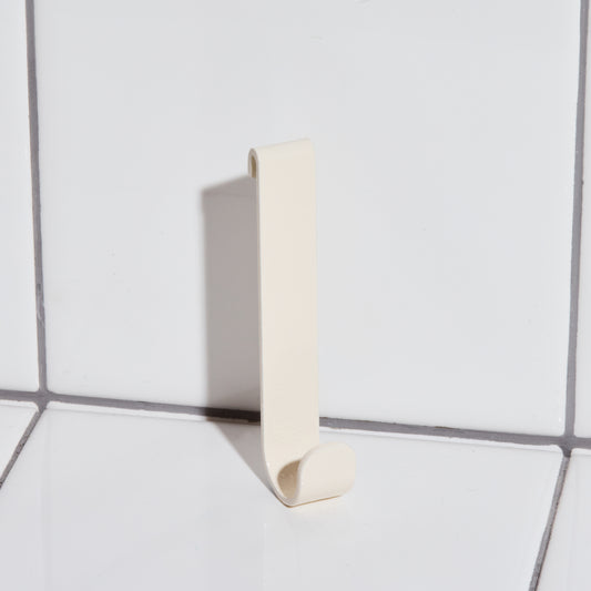 Aluminum hook in sand.