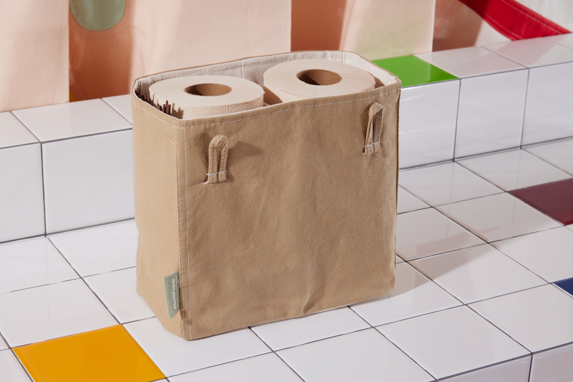 TP Tote in Desert detail view packed with toilet paper in bathroom