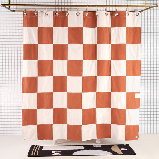 Re:Canvas Checker Clay front view of curtain hanging in a bathroom.