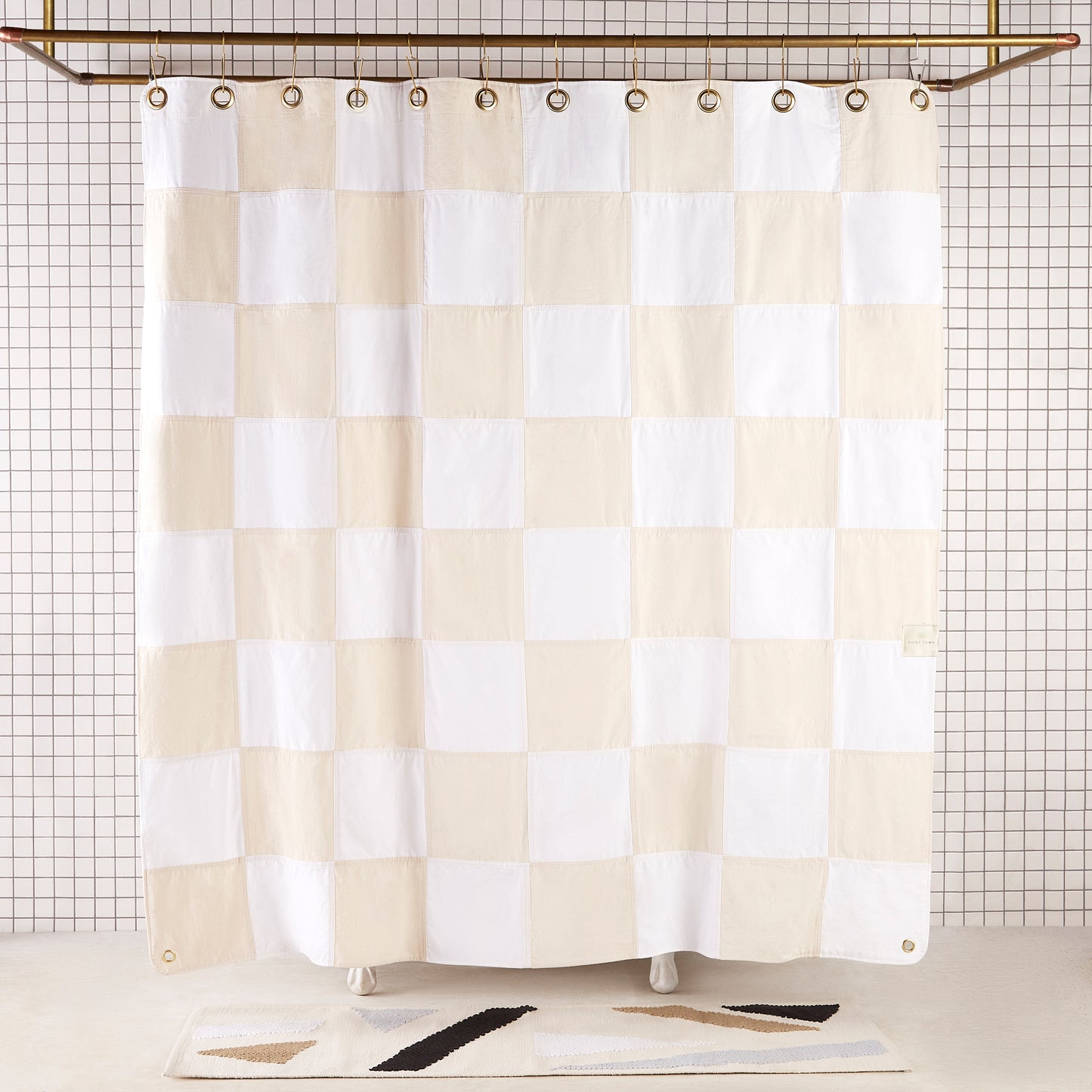Re:Canvas Checker Sand front view of curtain hanging in a bathroom.