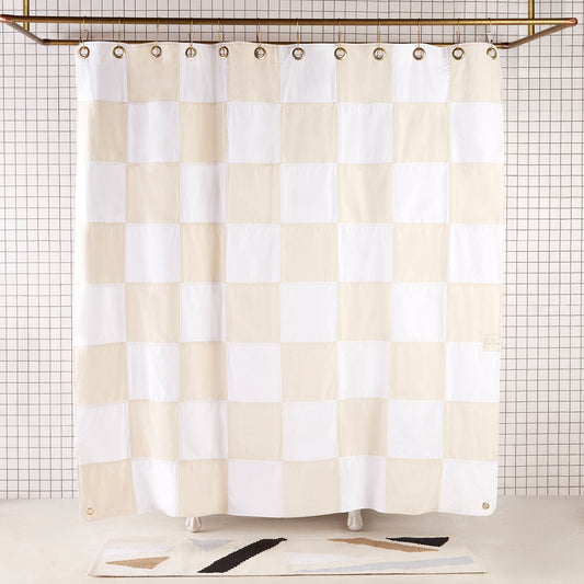 Re:Canvas Checker Sand front view of curtain hanging in a bathroom.