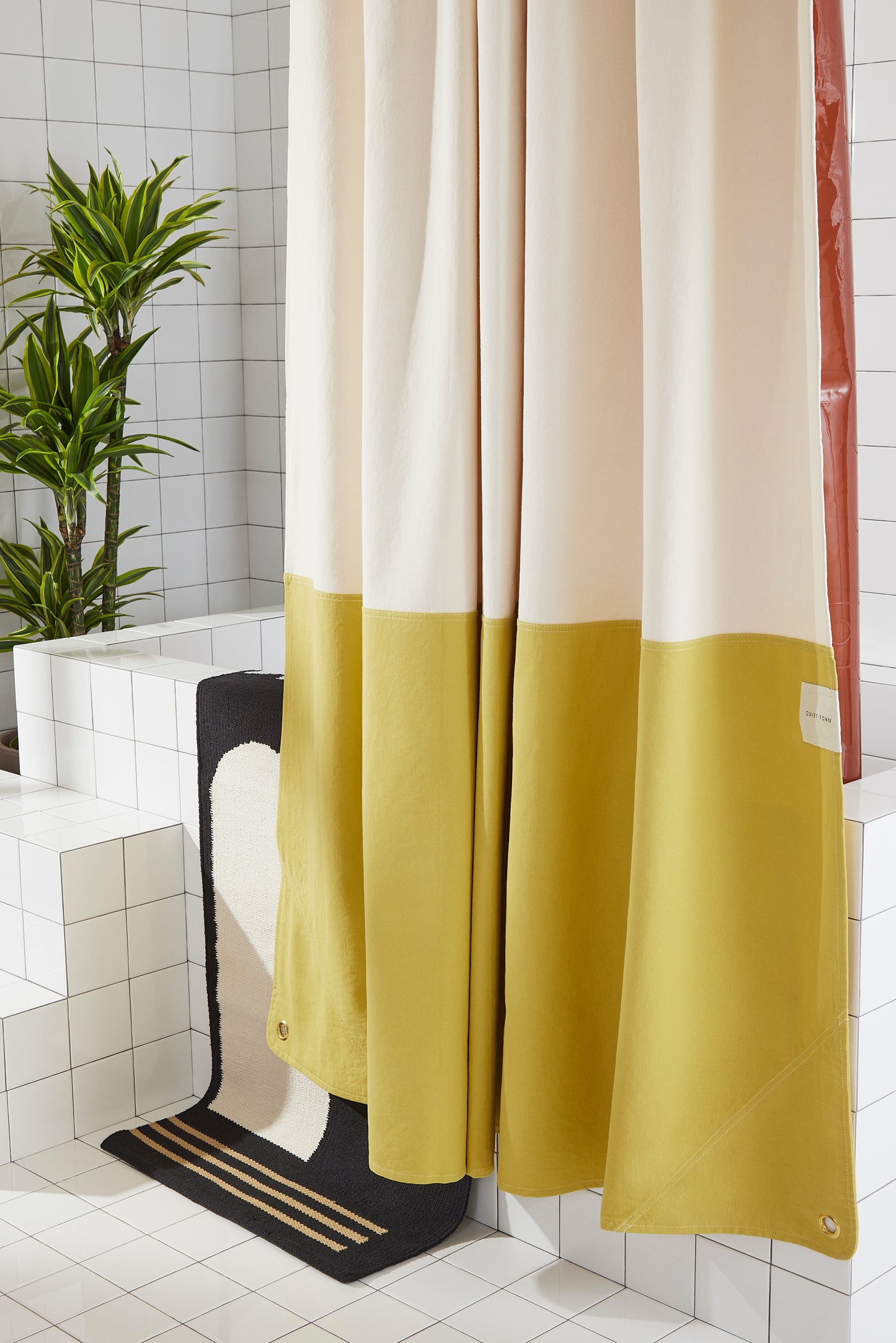 Orient Hesse side view of curtain hanging in a bathroom.