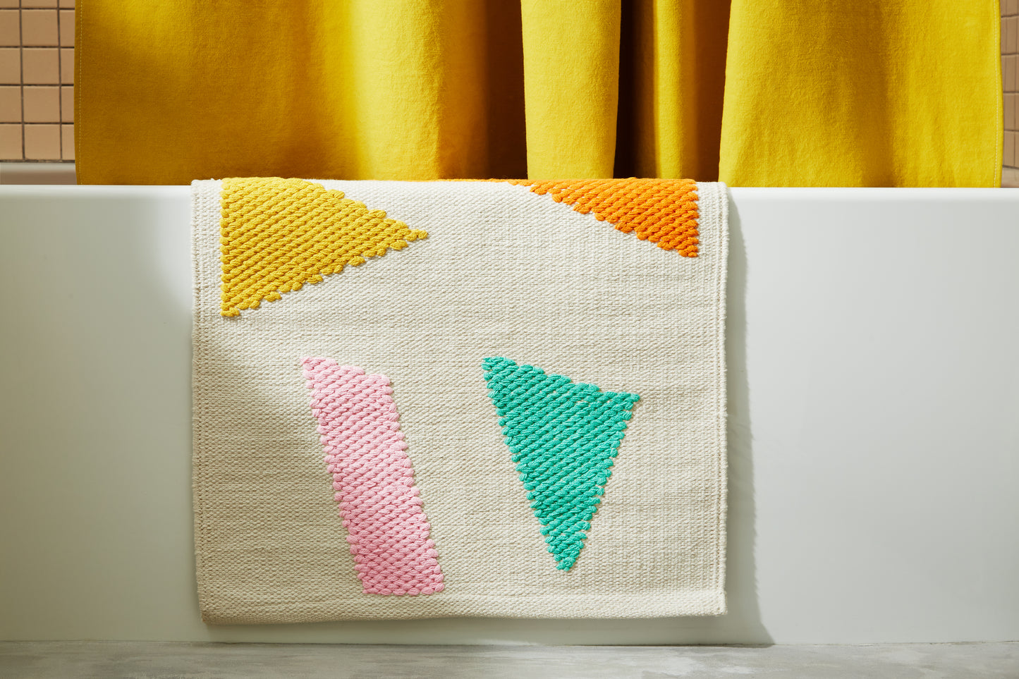 Ataco Canyon bath rug draped on edge of bath tub