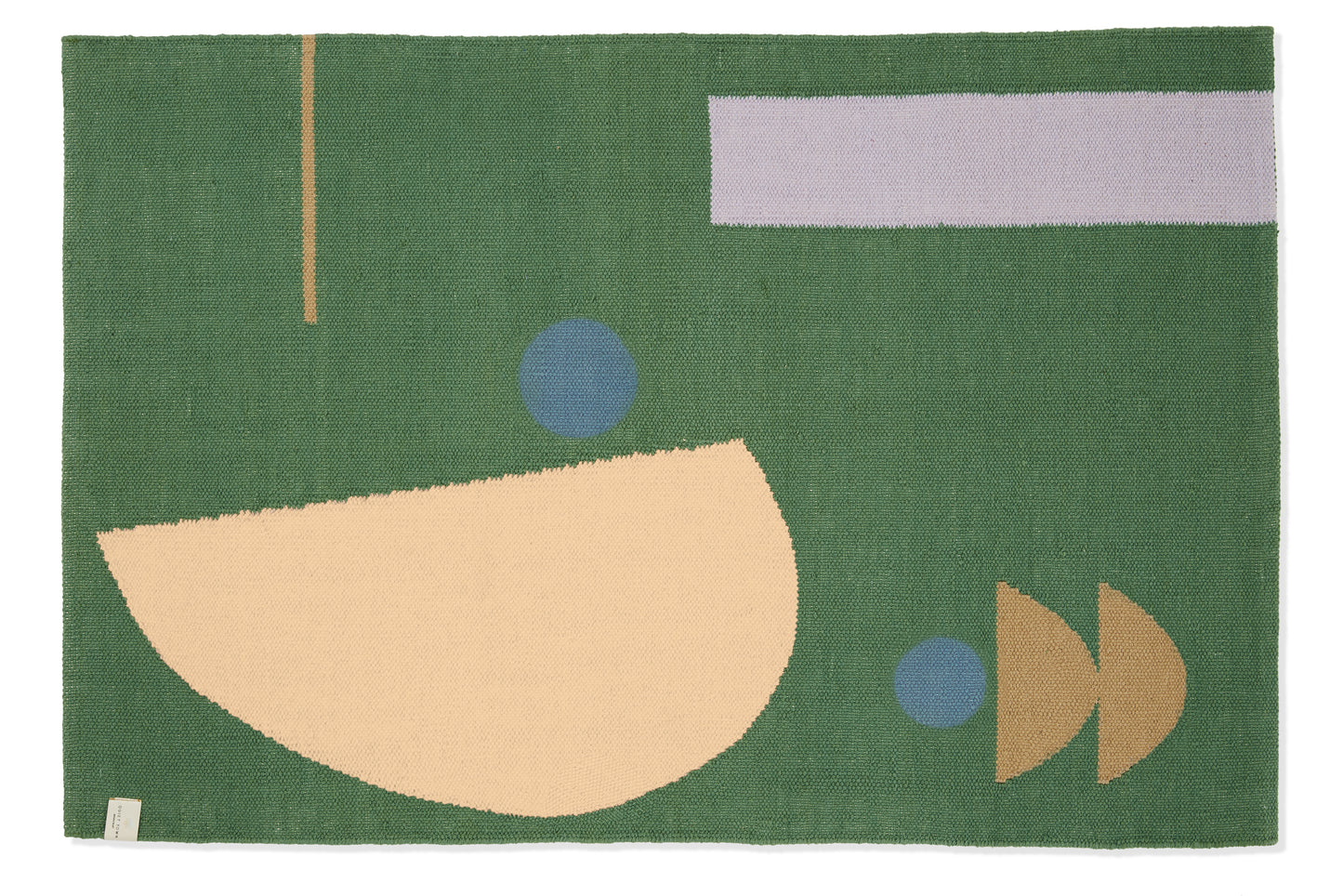 Green bath mat rug with organic shape pattern, shot against white backdrop.