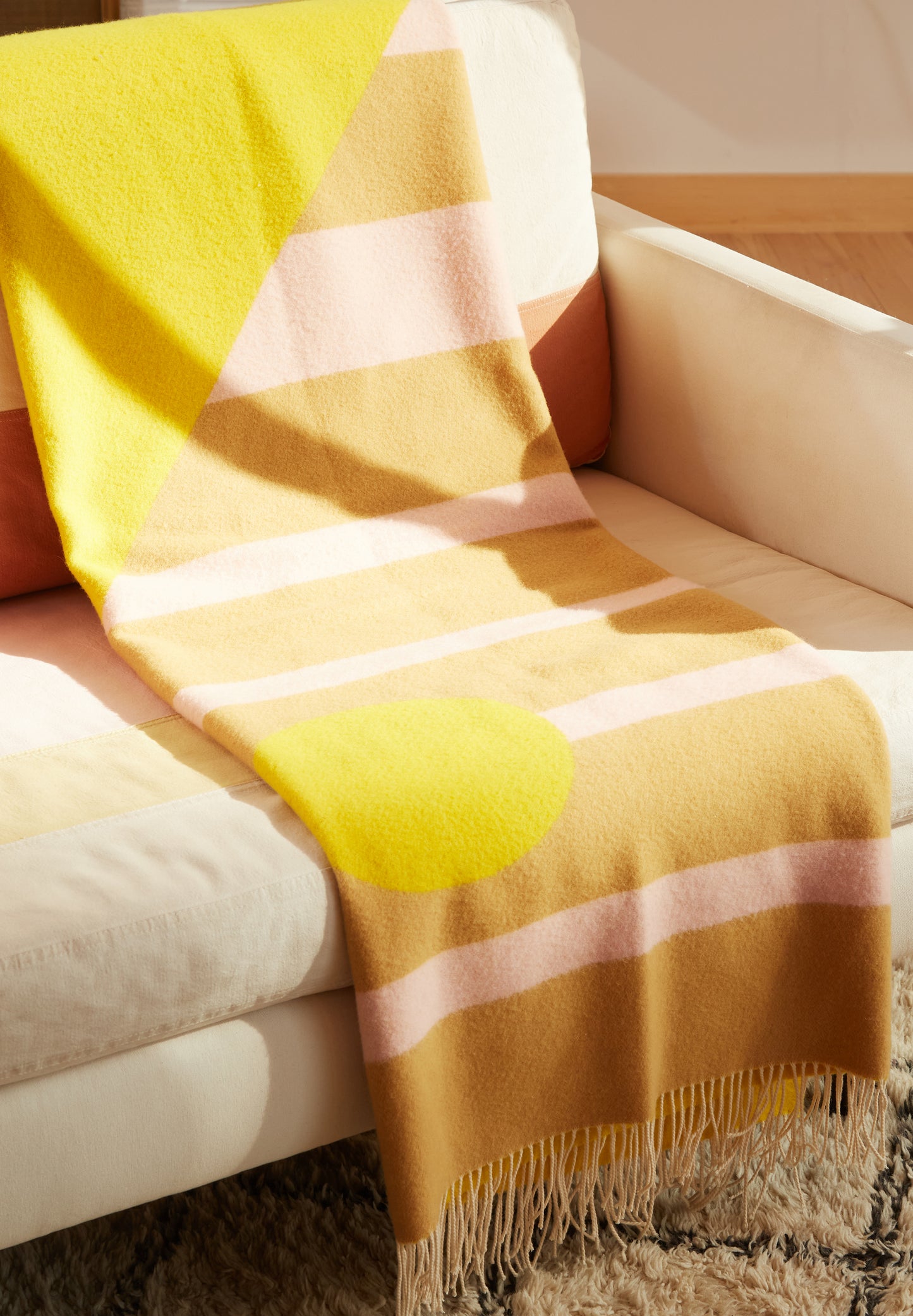 Beacon Canyon Blanket folded and draped on sofa