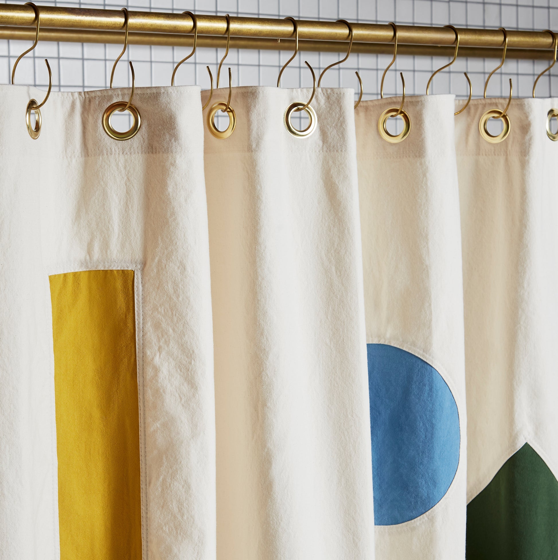 Beacon Pine detail view of grommets and hooks hanging from shower curtain rod.