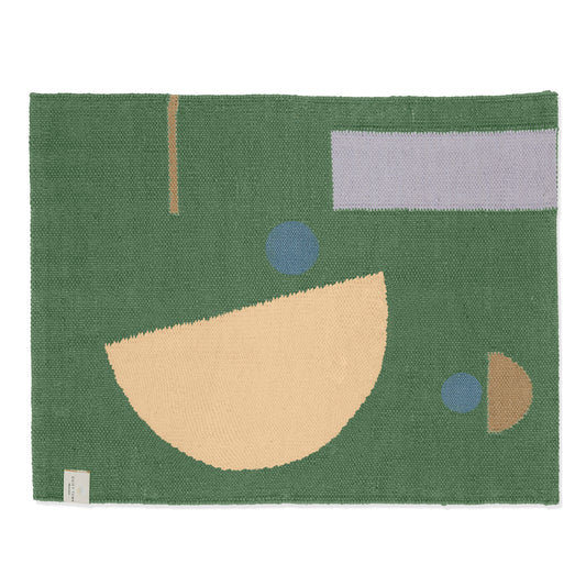 Green area rug with organic shape pattern, shot against white backdrop.