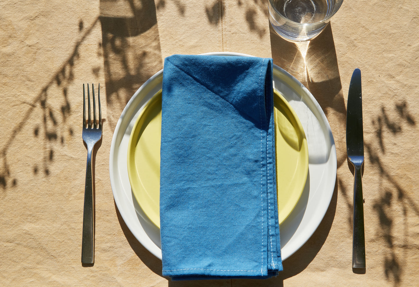 Naturally Dyed Tablecloth for 8 in Eucalyptus detail view with tableware