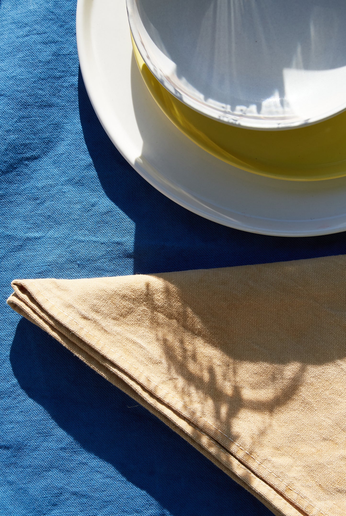 Naturally Dyed Napkins in Eucalyptus detail view with tableware