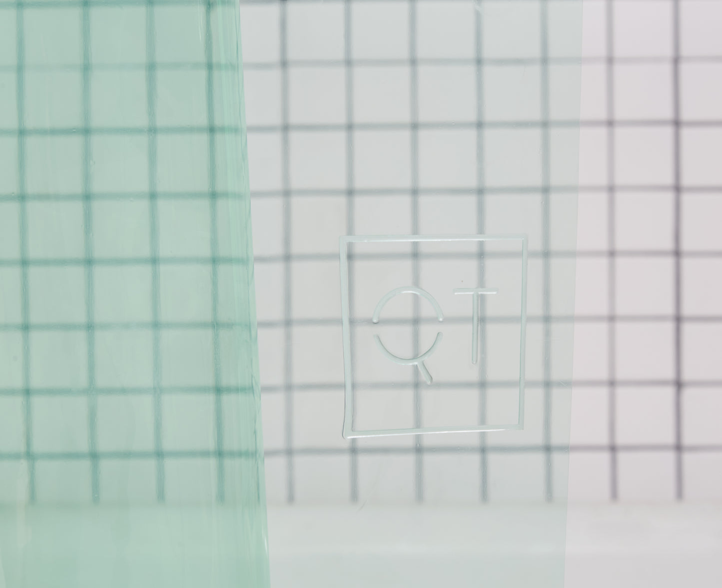 Sun Shower High Detail view of the Quiet Town logo embossed on the shower curtain.