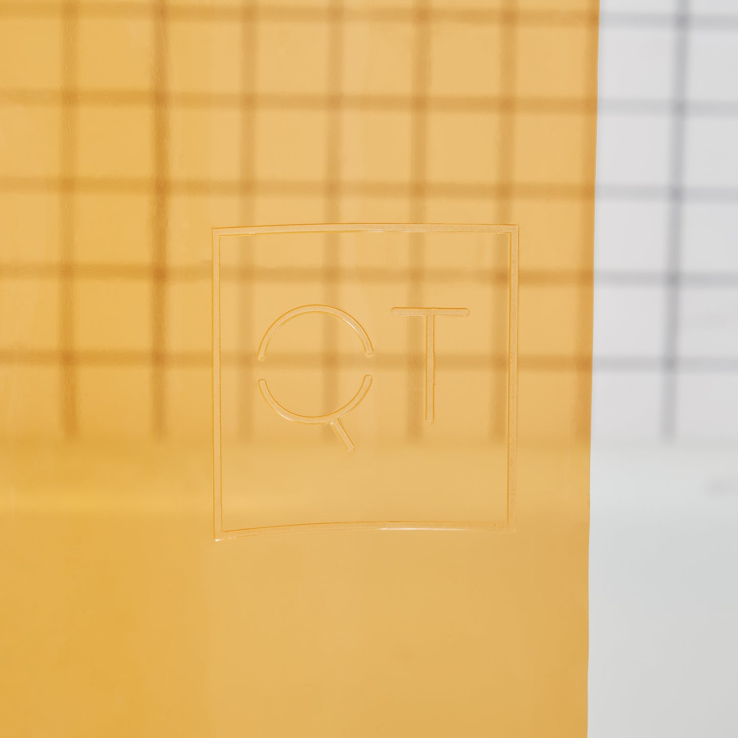 Sun Shower Juice Detail view of the Quiet Town logo embossed on the shower curtain.