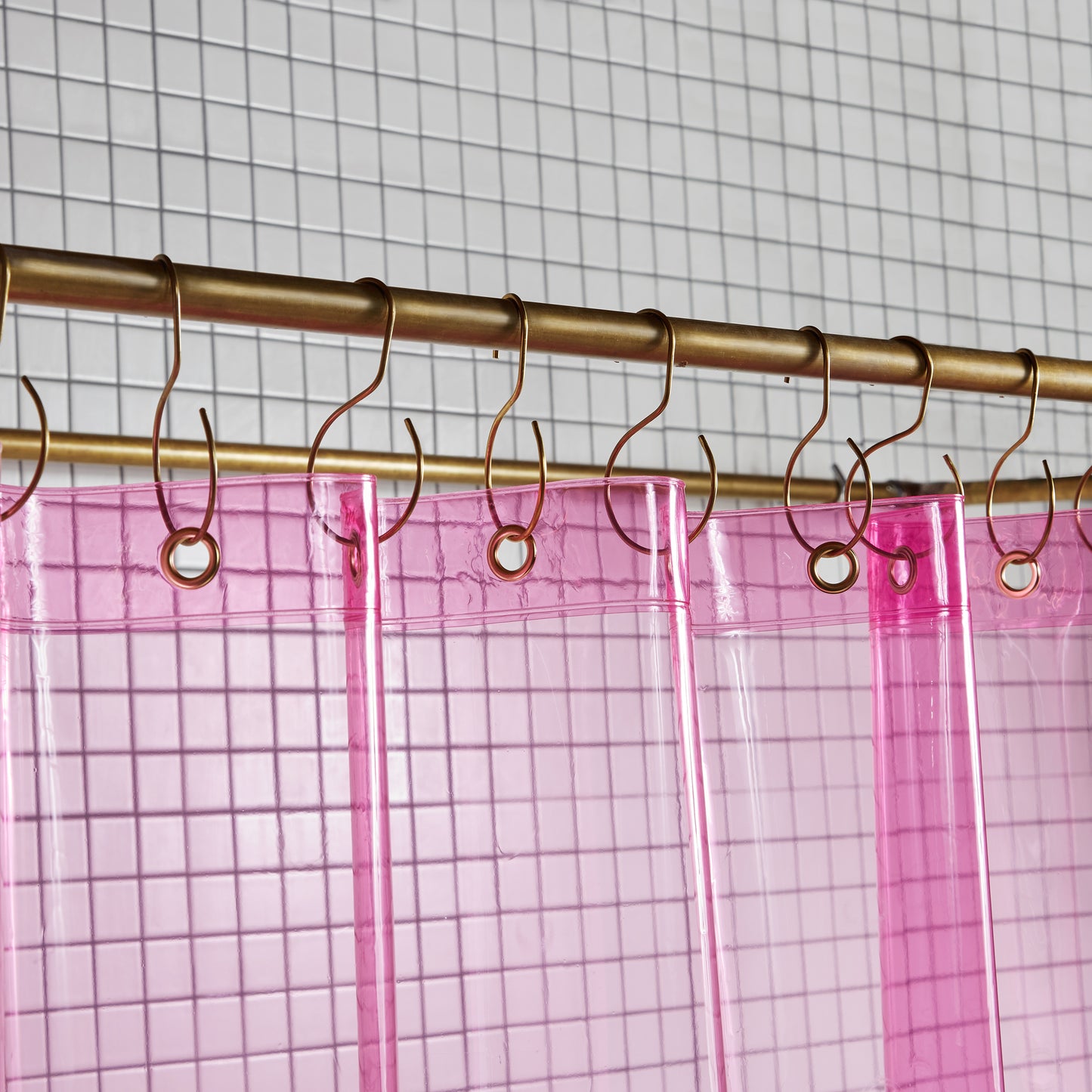 Sun Shower Phlox detail view of grommets and hooks hanging from shower curtain rod.