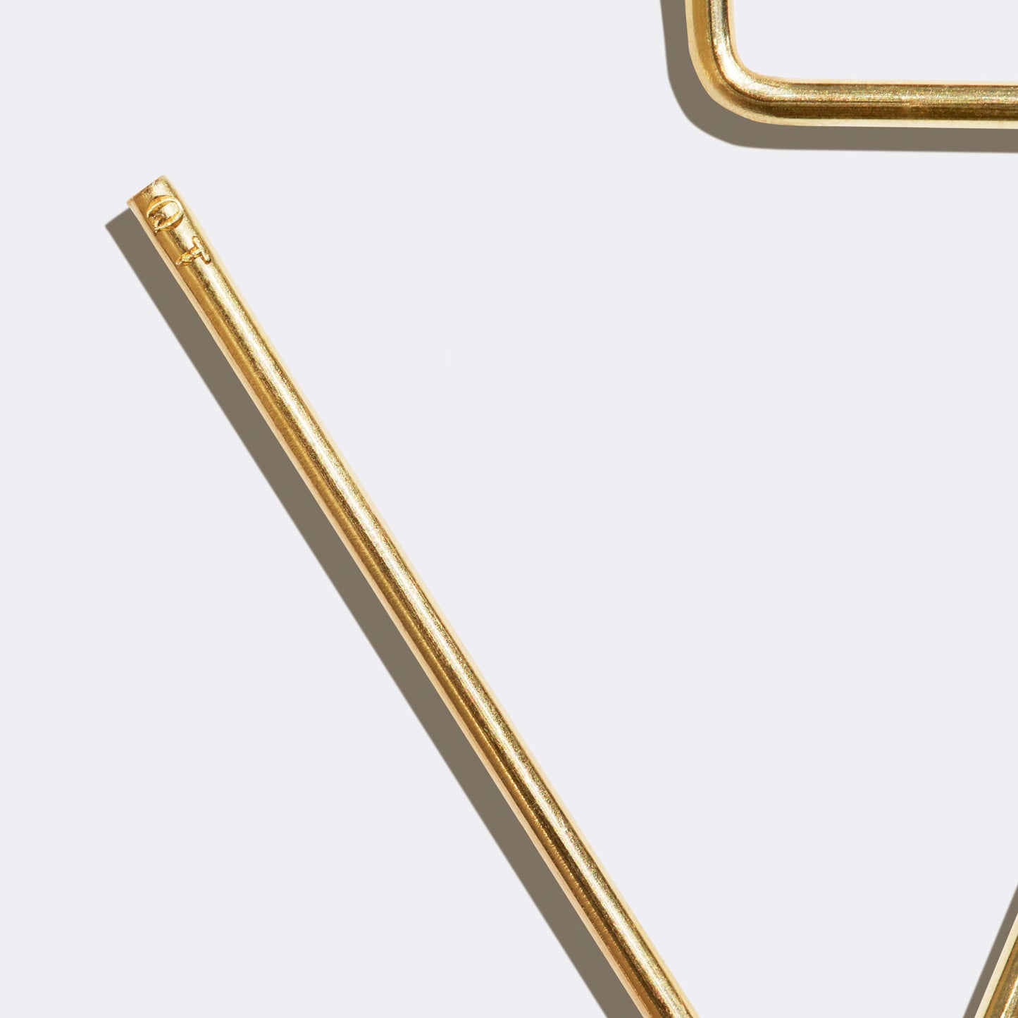 Venice Hook Brass detail view of embossed QT