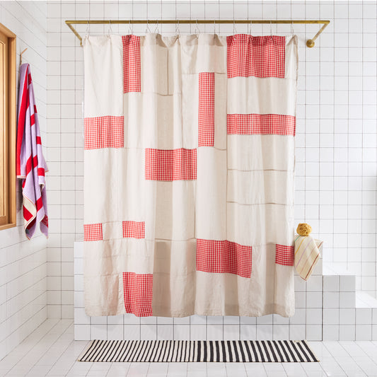 Shower curtain with red and white checkered pattern in a bathroom setting