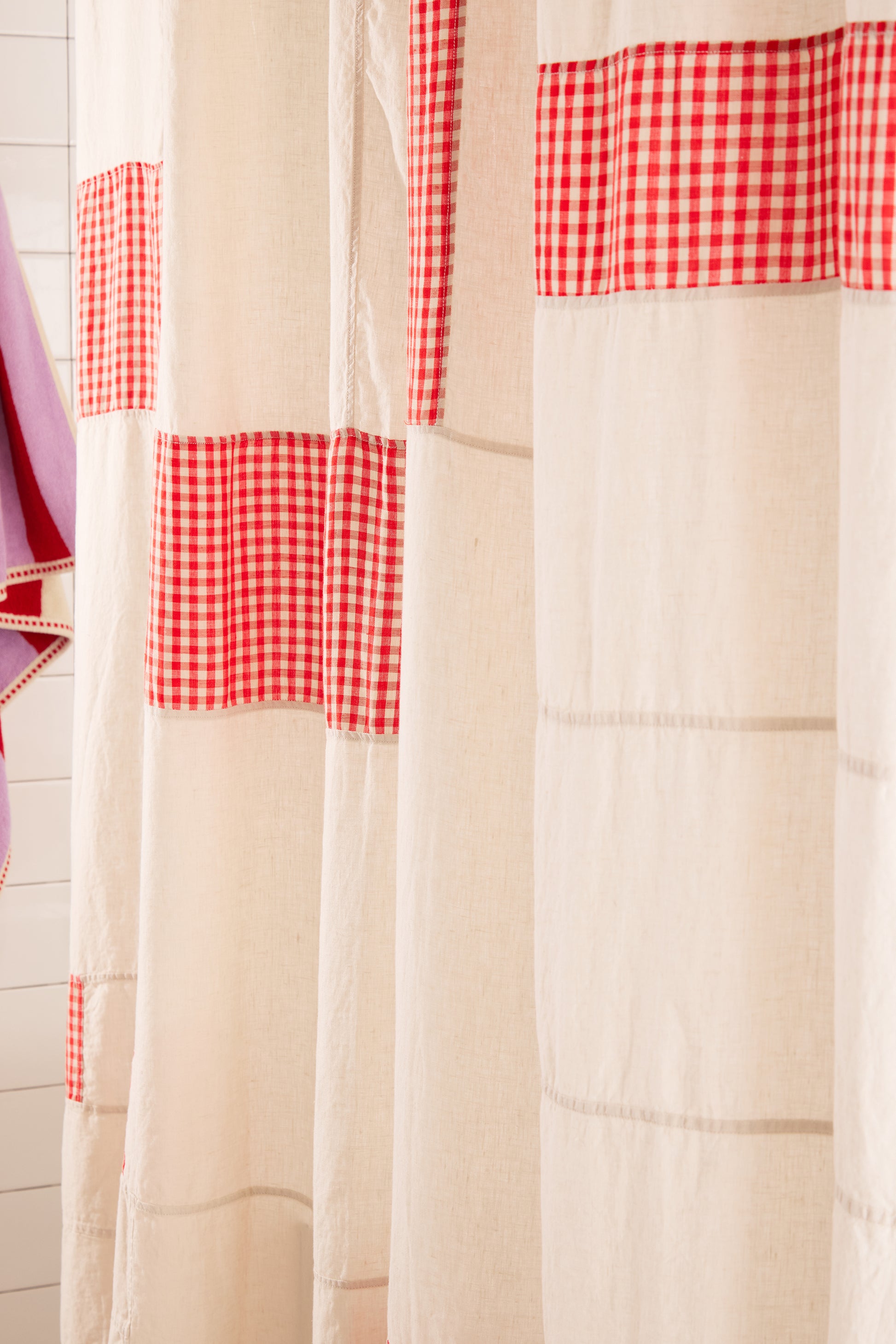 cream shower curtain with red and white checkered squares