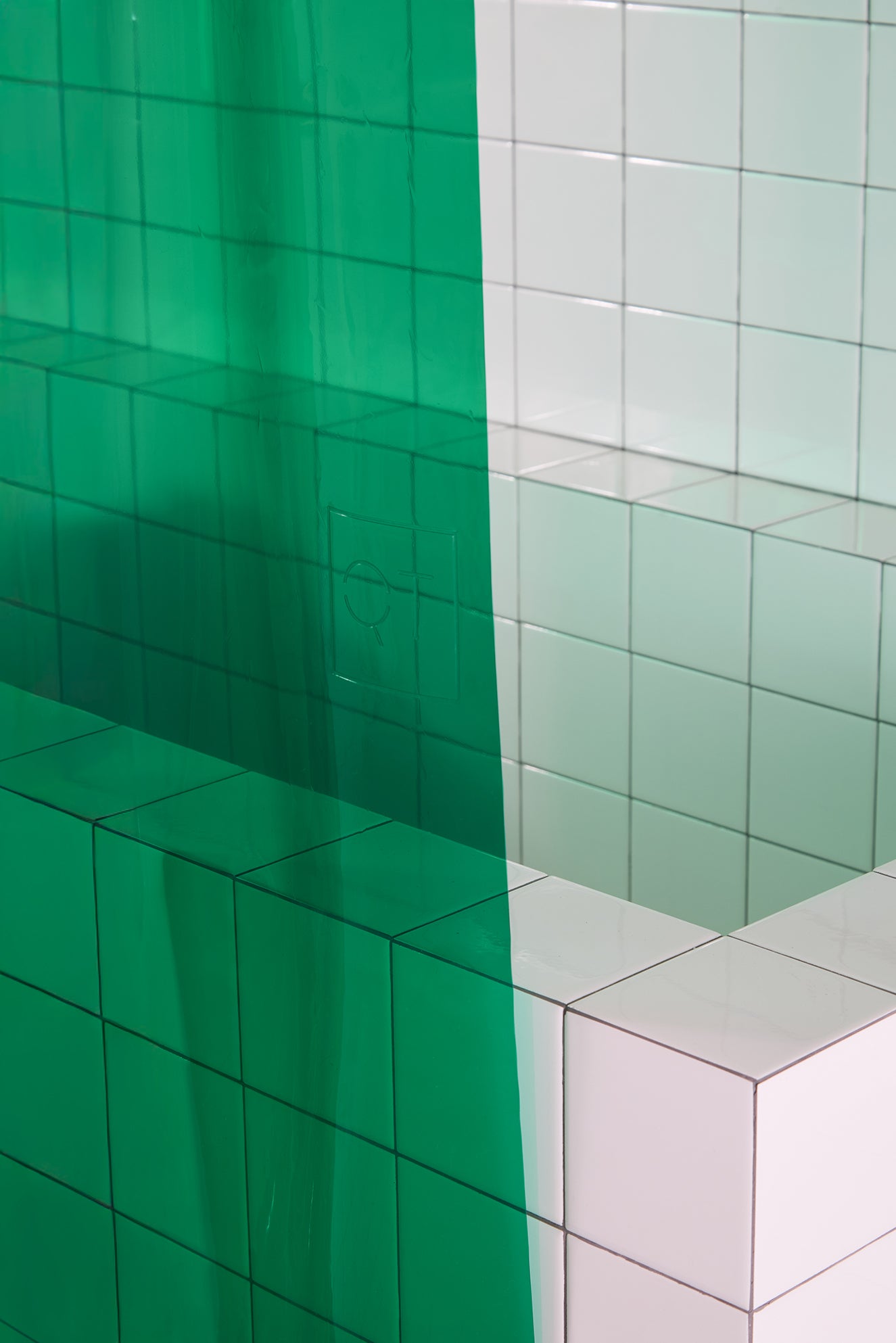 Green curtain in a white tiled bathroom.