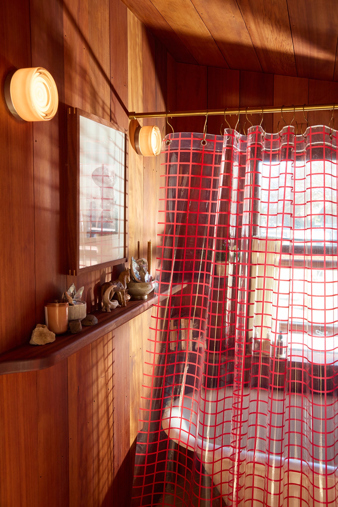Wooden interior  bathroom with a shelf and red checkered curtain
