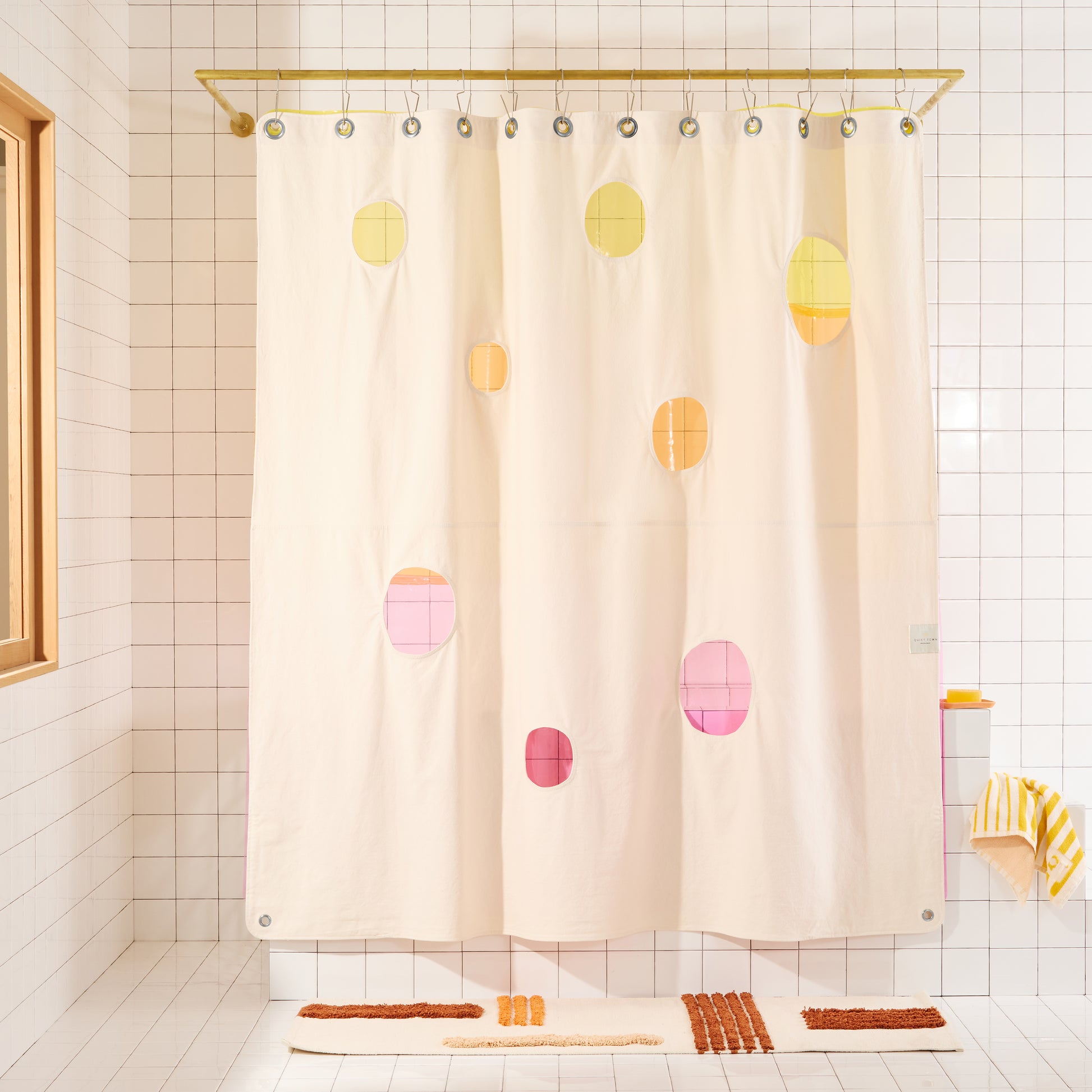 Bubble Sand front view of curtain hanging in a bathroom and layered with Sun Shower Lido Pop