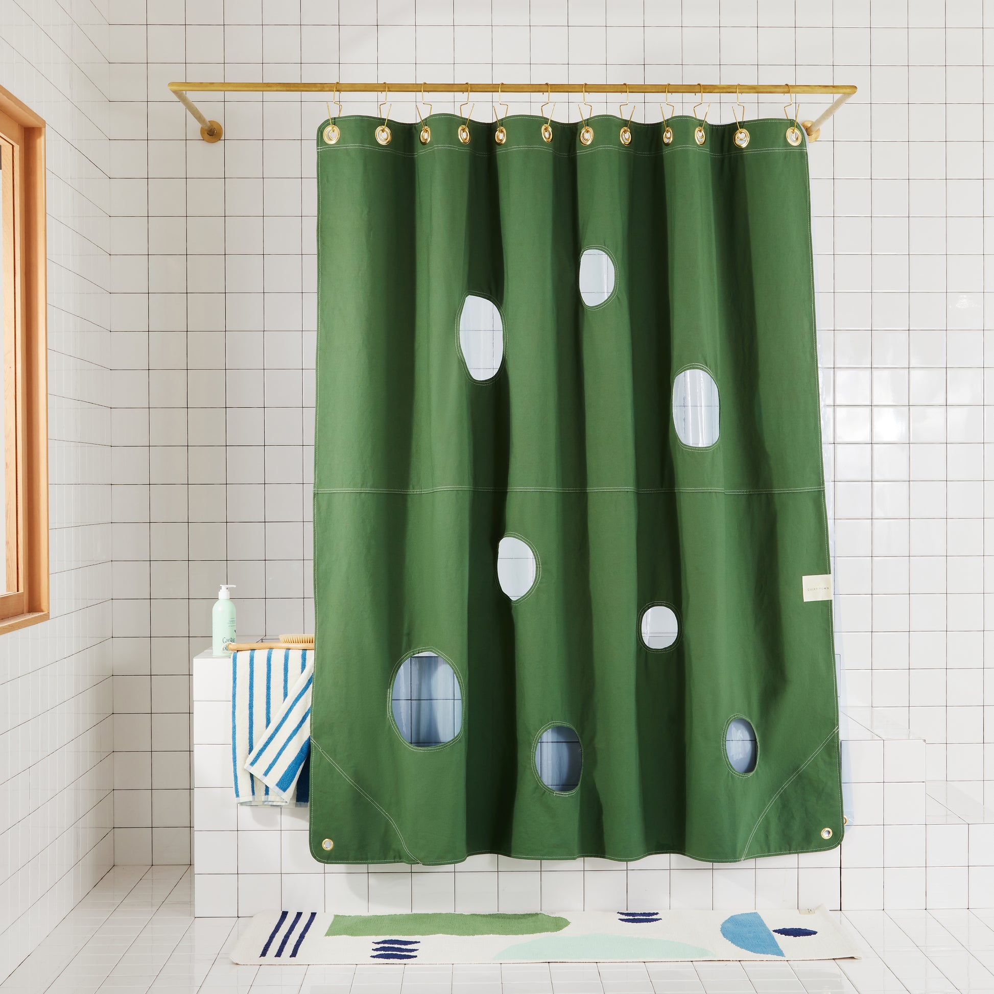 Bubble Pine front view of curtain layered with sun shower atlantic hanging in a bathroom.