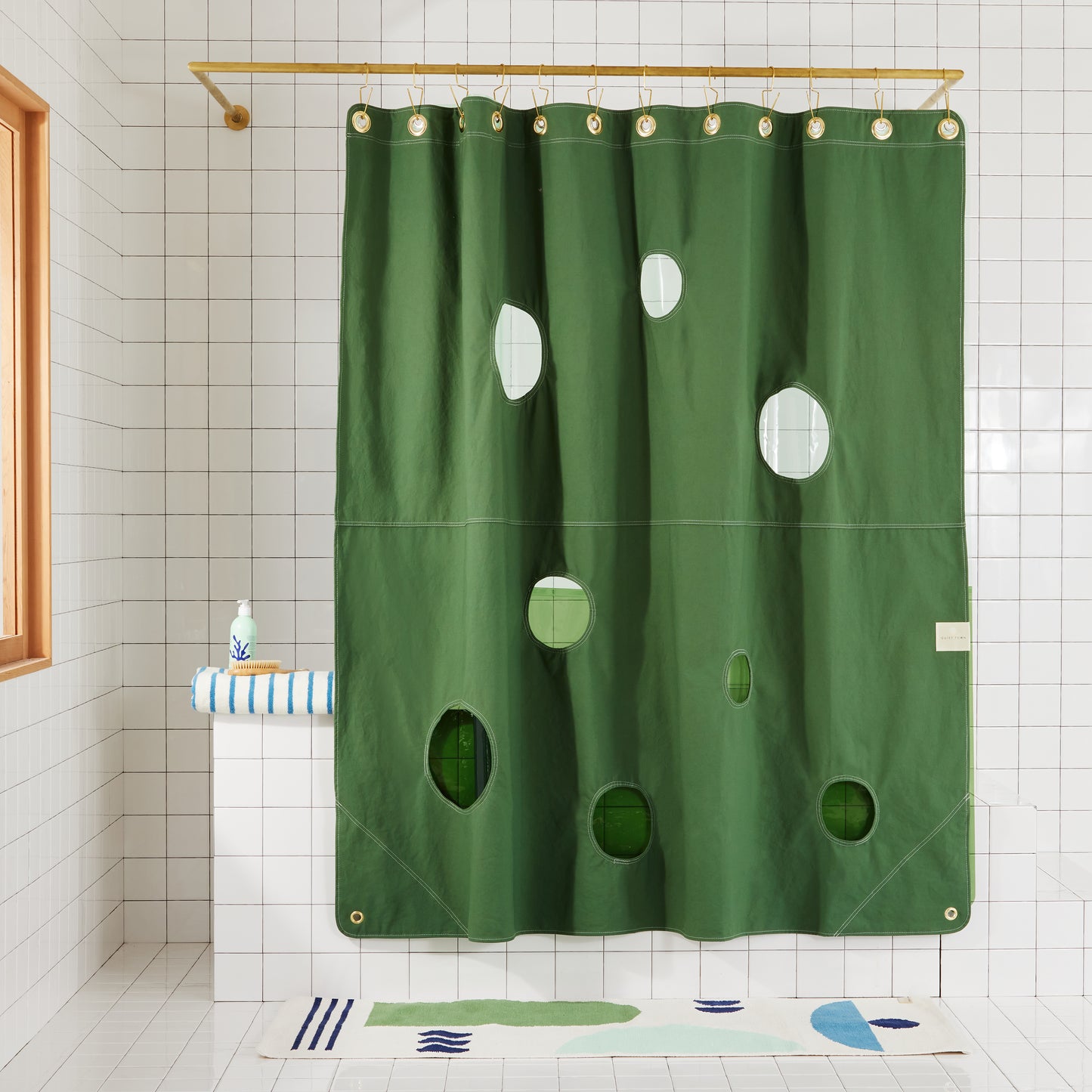 Bubble Pine front view of curtain layered with sun shower orient grass hanging in a bathroom.