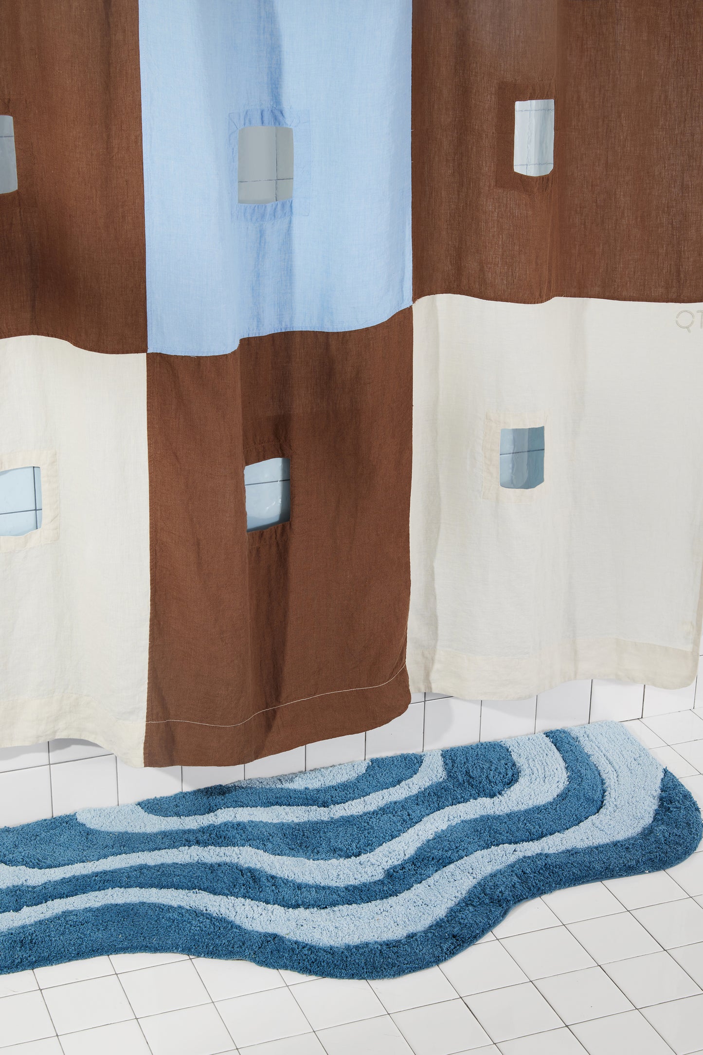 Center bottom of blue and brown checker linen shower curtain detail. 