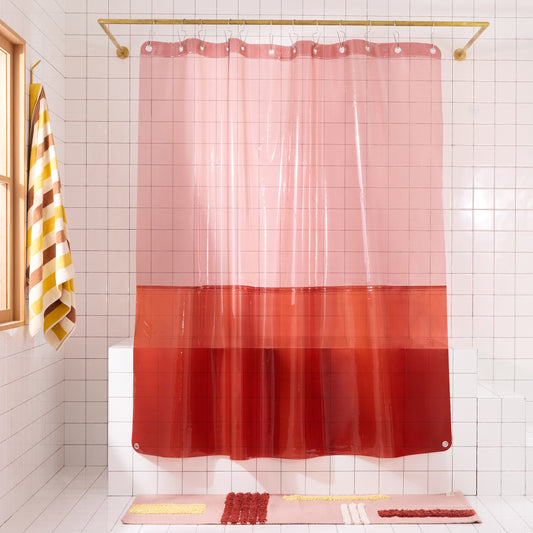 color blocked shower curtain hanging in white tiled bathroom. 