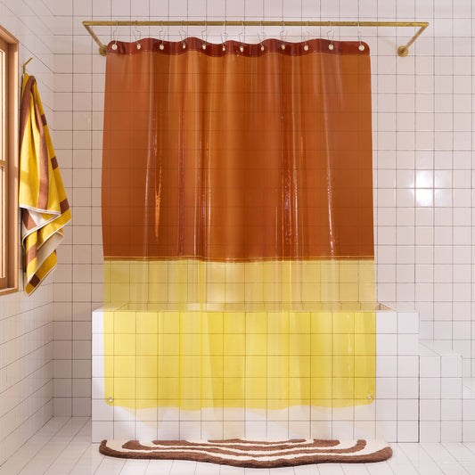 Orient color blocked sun shower curtain in cheetah hanging in white tiled bathroom.