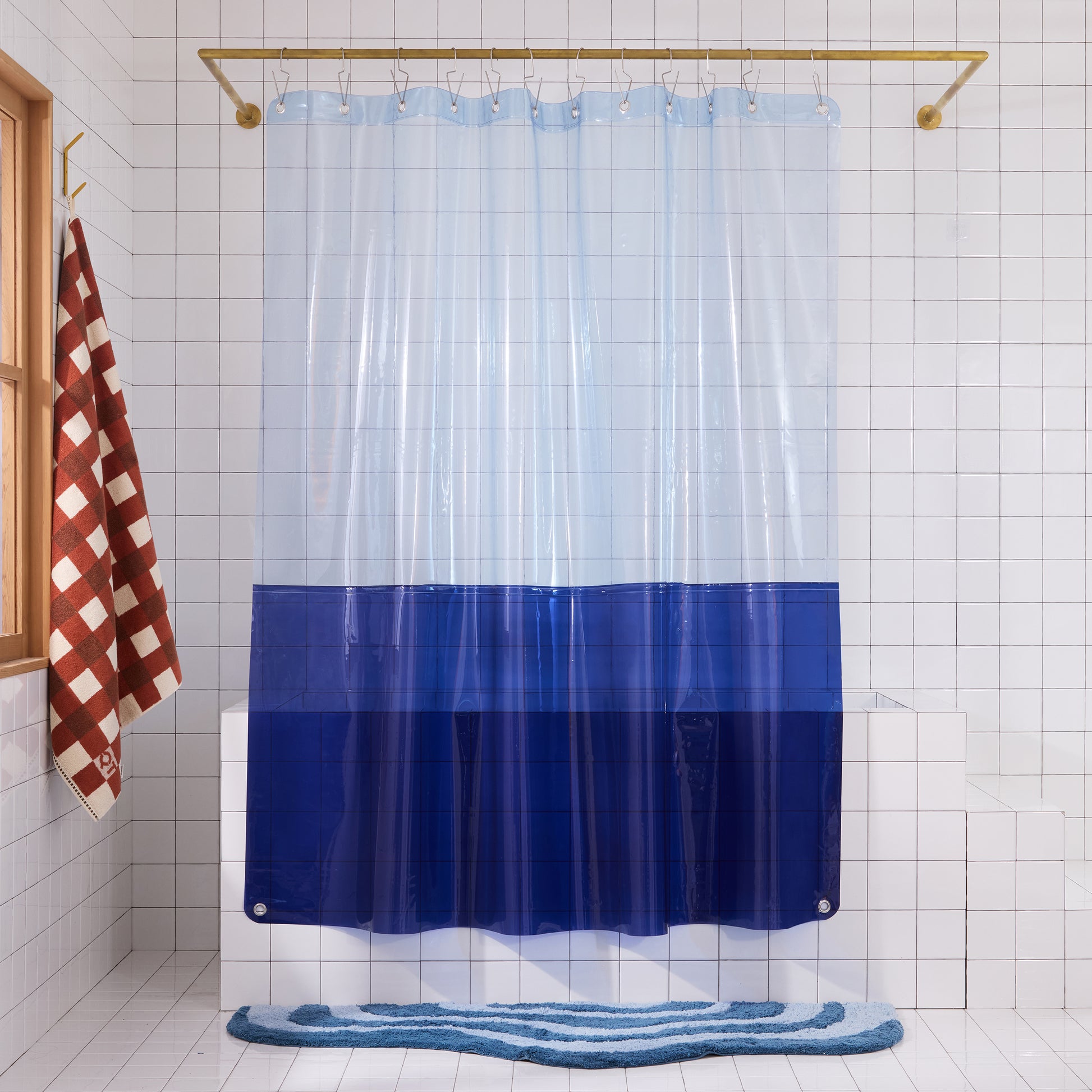 Sun shower orient in deep sea hanging in a white tiled bathroom. 